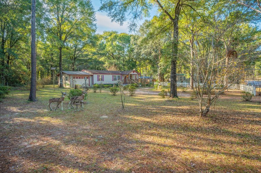 Welcome home to this well-kept 3-bedroom, 2-bath manufactured home nestled on a peaceful half-acre lot. Enjoy quiet mornings on the covered front porch and relaxing evenings on the large deck--perfect for soaking in the outdoors or entertaining guests. Inside, you'll find a nice open layout with updated bathrooms and newer carpet in the living room and primary bedroom, creating a comfortable and move-in-ready feel. Additional features include an attached one-car garage and a yard building for extra storage or hobbies. This property offers the perfect blend of space, comfort, and tranquility don't miss your chance to make it your own! To top things off this home will come fully furnished making for an easy move in.