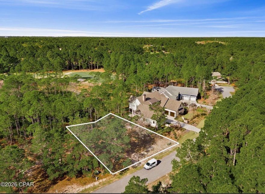 This beautifully wooded homesite located in Wild Heron Coastal Sanctuary is perfectly positioned on a quiet cul-de-sac that overlooks the 8th green of the Greg Norman-designed Shark's Tooth Golf Course, offering peaceful views and exceptional privacy with a golf course buffer behind the lot. Residents enjoy resort-style amenities including a lakefront pool, fitness center, boathouse with dock access to Lake Powell, kayak and paddle board storage, walking trails, parks, and community gathering areas. Golf enthusiasts can also enjoy the renowned Shark's Tooth Golf Club, available through Watersound Club membership. Ideally located just minutes from the Gulf of Mexico and Scenic Highway 30A.