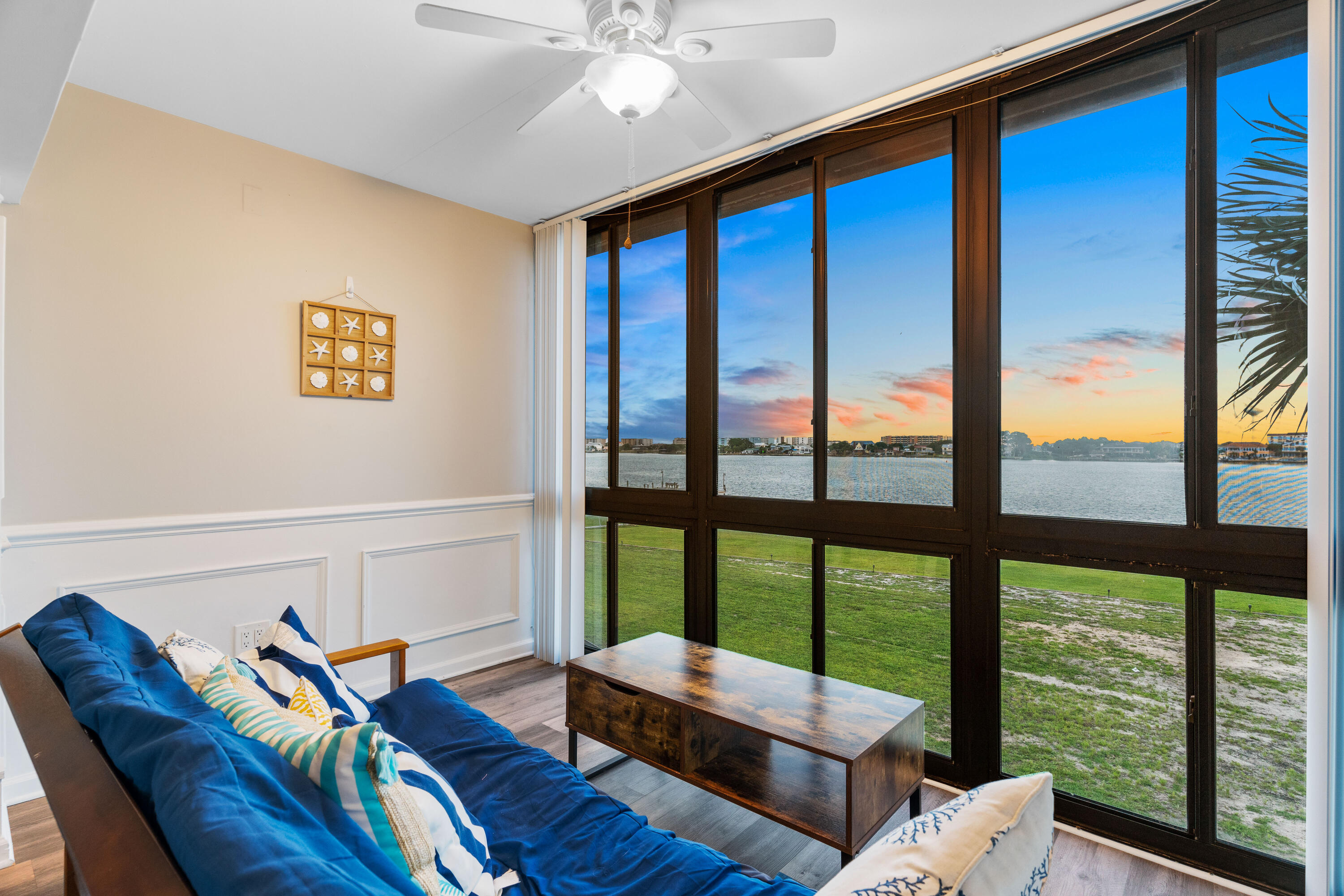 Experience waterfront living in this beautifully remodeled, fully furnished condo--featuring a 3.5% fixed-rate VA assumable loan--with breathtaking sunrise and sunset views. The updated kitchen features white appliances, quartz countertops, and a designer tile backsplash, opening to a spacious living and dining area. A bright sunroom with large windows invites you to relax and take in the stunning horizon. With two light-filled bedrooms and 1.5 renovated bathrooms featuring modern vanities, fixtures, and tile floors, this home blends comfort and style. The condo is sold turnkey--from washer and dryer to silverware--and is currently a successful Airbnb, offering immediate income potential or a seamless move-in. Perfect as a personal retreat or investment, this coastal gem is ready to enjoyed!