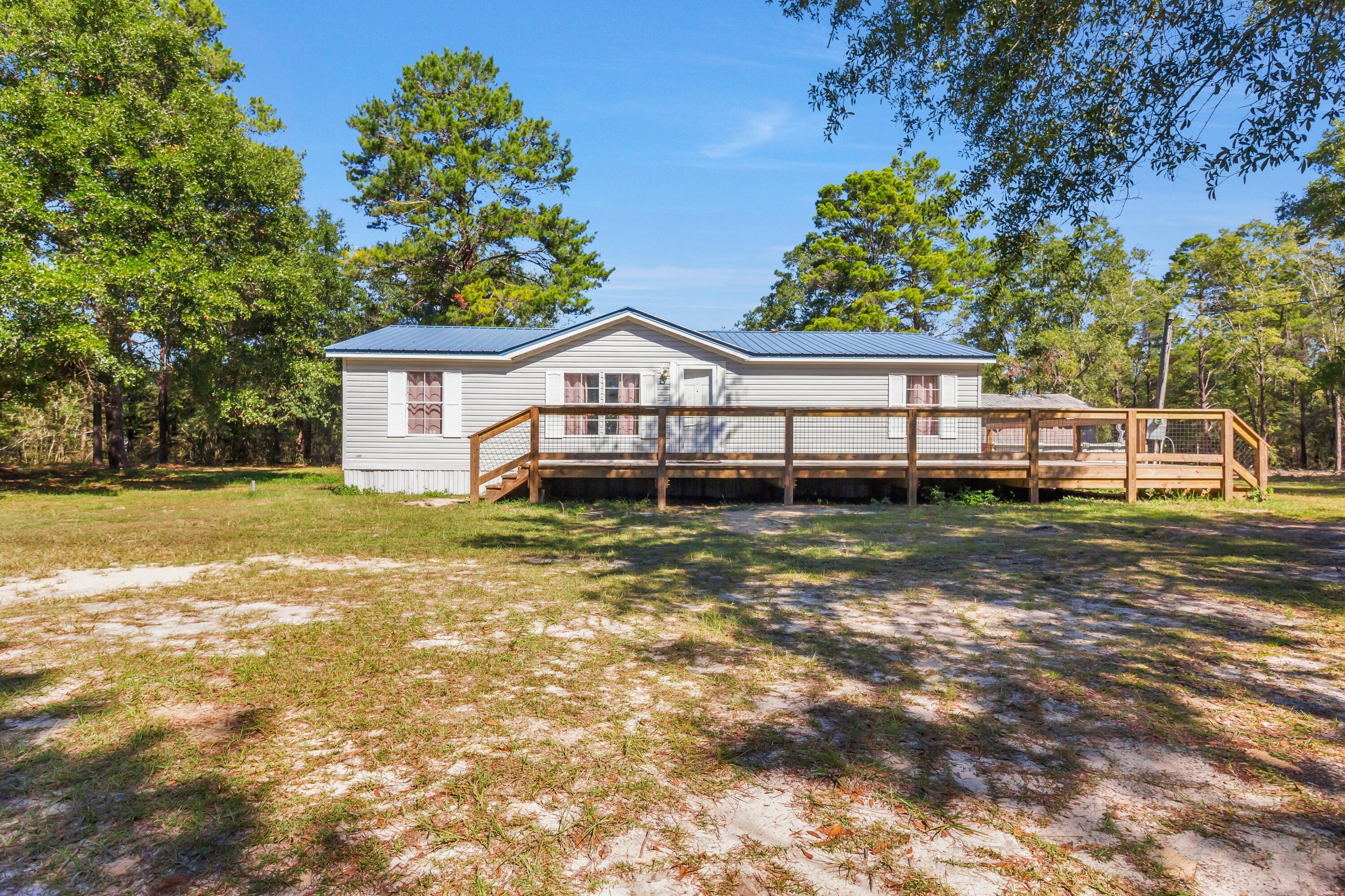 Country Living minutes away from the Beaches and Freeport!Discover this beautifully updated home situated on 5 acres of partially cleared land, offering privacy, space, and endless potential. The property features a brand new deck overlooking a large above-ground pool, perfect for enjoying Florida's outdoor lifestyle.Recent upgrades include an abundance of interior renovations, ensuring move-in readiness and peace of mind. The land offers both open and wooded areas--ideal for recreation, gardening, or future expansion.Conveniently located near the rapidly growing town of Freeport and just a short drive to the Emerald Coast's beautiful beaches, this property combines the best of country living with easy access to shopping, dining, and coastal amenities