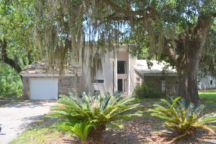 The PERFECT CANAL FRONT HOME w/ bay views, front yard sago palms and fruit trees,large Majestic oak trees and level yard. Easy access to bay by boat from the back yard. VERY Large workshop and bonus room WHICH NEEDS some work . All this in a quiet neighborhood = EASY BAY AND RIVER ACCESS FROM YOUR OWN BACKYARD.