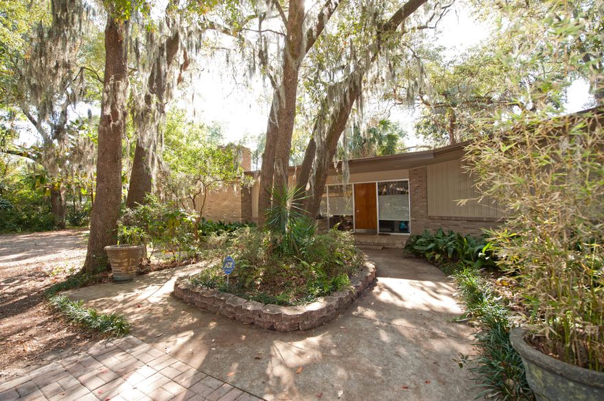 This sprawling home is nestled among gorgeous shade trees on a 1.37+ acre spacious waterfront lot with awesome water views. Front and back yards have large, mature shade trees with a variety of fruit-bearing plants. There are two covered boat slips (one for a 40+ft motor vessel and one with a boat sling for a 20ft ski or fishing boat). Detached covered carport, multiple patios and a greenhouse are located for your convenience. Inside you will find an abundance of light shining through the large windows overlooking the water. The main living area has 10ft ceilings and a 5ft wide wood burning fireplace with insert. Breakfast and kitchen areas are tiled and the kitchen has stainless appliances. Seller is offering a one year Home Warranty for the buyer.