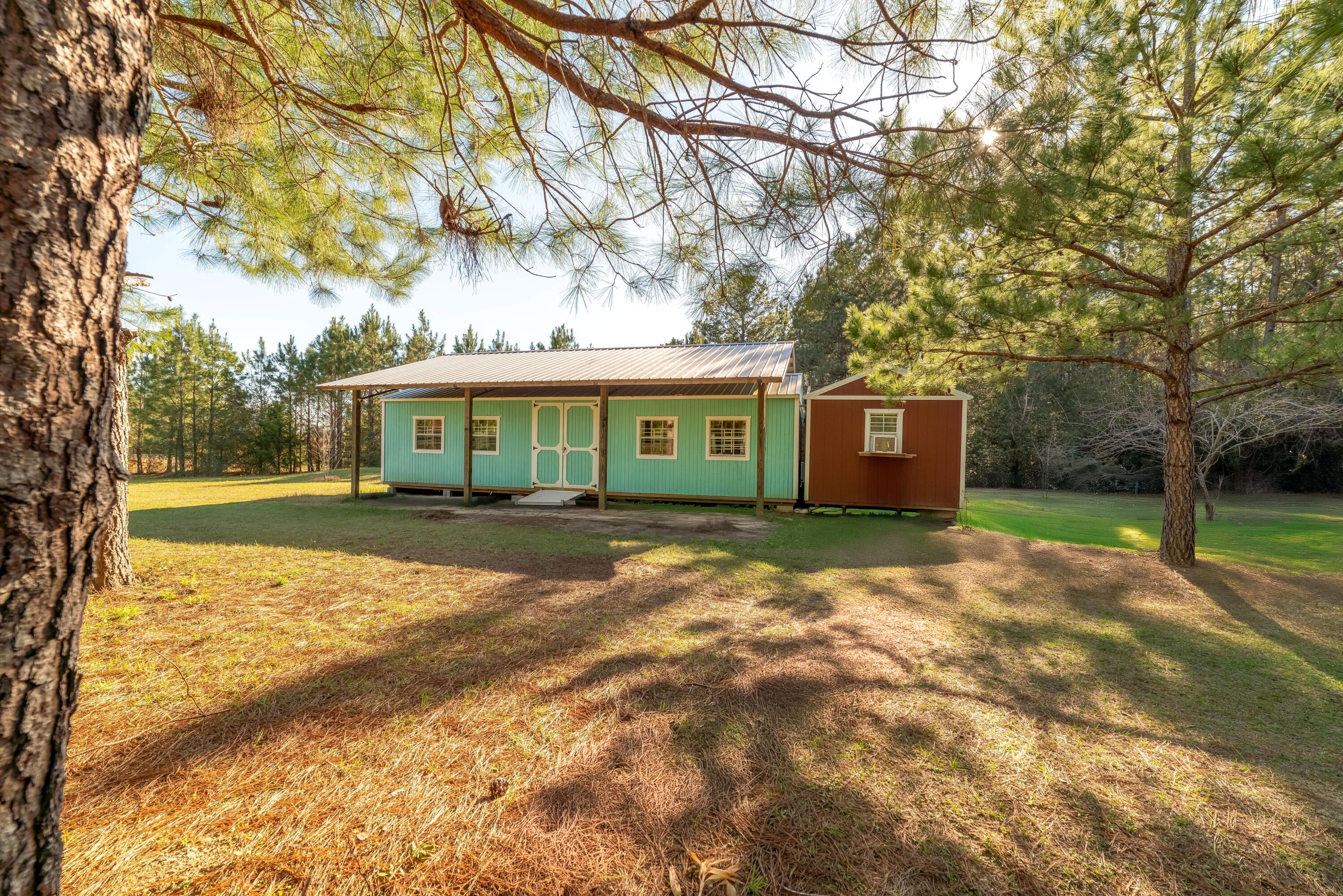 Secluded 1-Acre Retreat with Buildings, Pole Barn, Well & Septic - Ready for Your Finishing Touches! Escape to your own private 1-acre oasis in Ponce De Leon, Florida! This versatile property is perfect for a weekend getaway or a small home with the right finishing touches. Property Features: Two Buildings: A 16' x 40' building and a 12' x 32' building, offering ample space for living, storage, or workspace. Pole Barn: A 30' x 36' pole barn provides covered protection for the new 16' x 40' building and the 12' x 32' building is placed adjacent with work already started to join the two and add a doorway conjoining them. Utilities in Place: 16' x 40' has insulation and is wired for electrical, plus an existing well and septic system already on-site saving you time and investment.