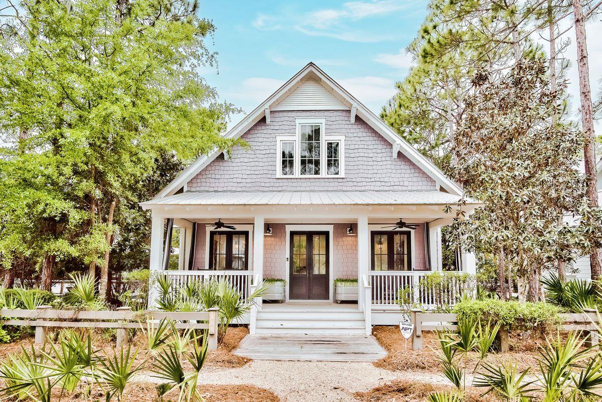 This attractive custom beach cottage has many surprises with its extensive floor plan and private pool on one of the largest lots in WaterColor. Carrara marble counters throughout, low-maintenance ipe decking, a Rinnai tankless water heater, and a central vacuum make luxury living easy. The full-width front porch provides a charming space to sit out on rockers with an icy drink or a good novel. Double doors lead into the airy open living space with volume ceiling and whitewashed walls from a nature-inspired palette. A stone fireplace provides a focal point for relaxing on sofas and watching TV. The formal dining area is perfect for entertaining, enhanced by the wine refrigerator for serving perfectly chilled drinks and aperitifs.