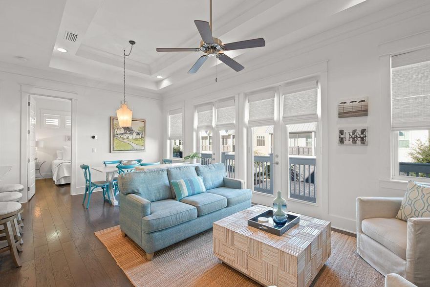 This fully-furnished Prominence townhome features several upgrades and offers an ideal 30A location. Well-maintained, this coastal retreat provides open main living areas with high ceilings and serene decor, as well as a beautiful chef's kitchen with granite countertops, stainless steel appliances, a glass tile backsplash, and a breakfast bar. Two sets of doors lead out to a front-facing balcony. Two spacious bedrooms offer elegant accommodations, and additional interior upgrades include wood shelving, custom blinds, and hardwood and tile flooring throughout. Located just one tier back from Scenic Highway 30A, this home is just steps from the community pool and directly across the street from the Hub.