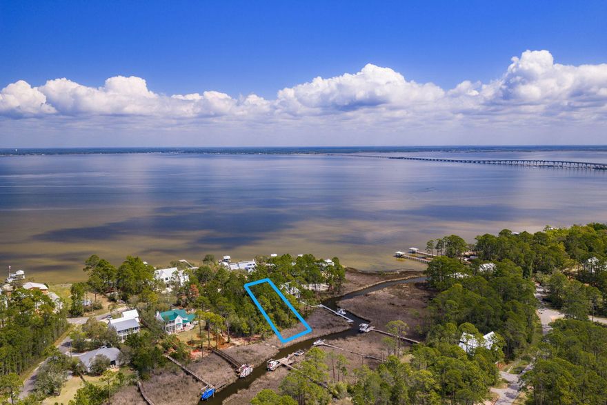 Build your life around the water--where every day feels like a getaway & every sunset is yours to keep. This rare .67-acre canal-front homesite offers direct access to Choctawhatchee Bay, inviting you to fully embrace the waterfront lifestyle. Design your dream home w/room for a dock & boat, and set out at a moment's notice--whether it's a sunset cruise to The Bay for dinner, a fun-filled Saturday at Crab Island, or a peaceful morning paddle boarding right from your backyard. Kayak the calm canal waters, cast a line at golden hour, or simply unwind and soak in the quiet beauty that surrounds you. Install your dock & bring your boat now--start enjoying the waterfront lifestyle immediately while you design and build your dream home.  With no build-out timeframe, you have the freedom to create exactly what you envision, all while already living the lifestyle most are waiting for.  The generous lot size offers endless design possibilities, including the potential for bay views depending on your vision. Tucked within a charming coastal neighborhood that feels worlds away, yet conveniently close to the beach, dining, shopping, and everything the Emerald Coast has to offer--this is an affordable opportunity to secure your place on the water and start living the lifestyle most only dream about.