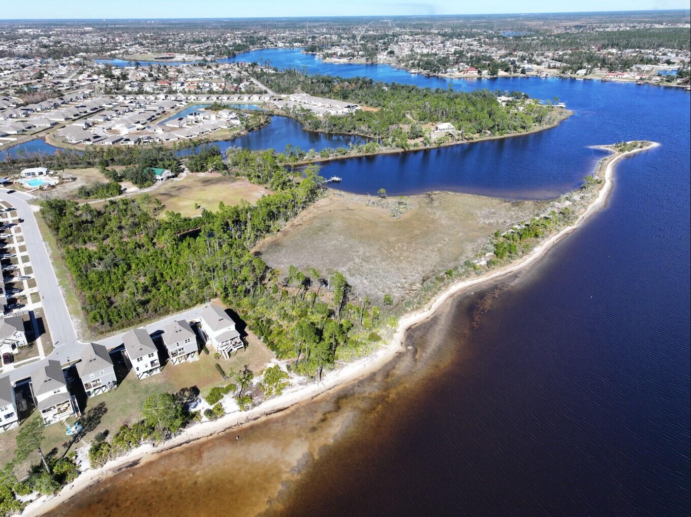 Discover this rare investment opportunity! 7.137 acres of prime waterfront property in Panama City, Florida. Located on beautiful East Bay, directly across from Tyndall Air Force Base. This parcel is on the last deep water access east of Panama City with plans already in place for a state-of-the-art marina.Fully intitled development opportunity with permitted commercial space totaling 16,310 sq/ft, and a 24,394 sq/ft parking lot. And 174 permitted slips. -47 Docks situated in the serene Osprey Inlet.-120 Docks located in the highly sought-after Callaway Bayou. -6 temporary mooring slips and 1 fueling dock with temporary mooring.This property is primed for development and designed to meet the growing demand for marina facilities.