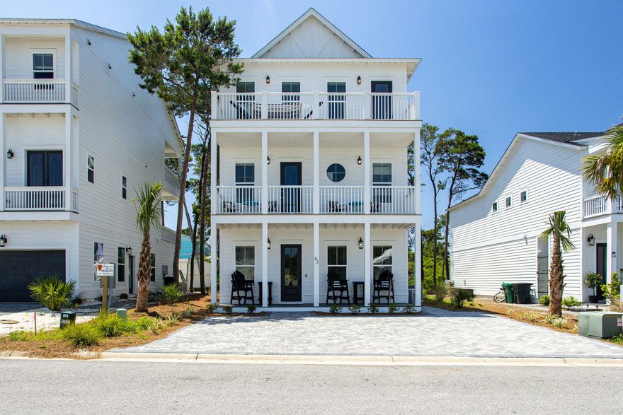 THIS HOME IS THE LOWEST PRICE PER SQ FOOT IN THE COMMUNITY AND PRICED TO SELL! Welcome to YOLO (You Obviously Love Oreos) This is the builder's home and has all the bells and whistles, framed paver driveway, 4 bedrooms with ensuites and two bunk areas and a large game room. This home also has a first-floor owners suite. Sleeps 15 easily! Every floor and every bedroom has a balcony. A fourth floor viewing deck has been added for Gulf views. This would make for a Great Investment Property and comes with Excellent Rental History. The home is upgraded with engineer hardwood throughout the home, quartz countertops, full tile showers and raised ceilings.  It is just a quick golf cart ride to the beach and the community pool is located right next door to the house.