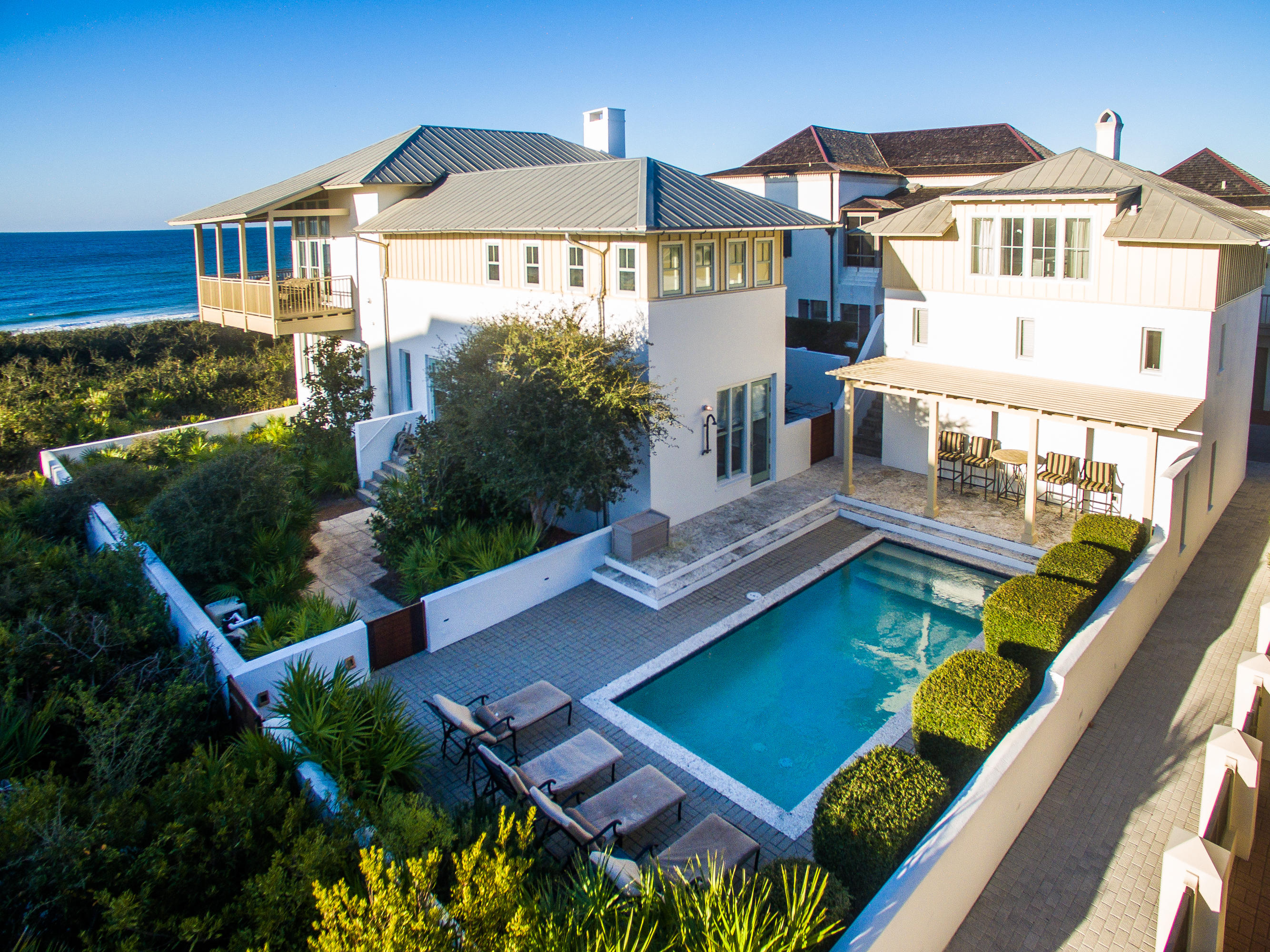 85'of'PARADISE'! This PRIME ROSEMARY BEACH GULF FRONT HOME has 180 degree views of the TURQUOISE GULF WATER & SUGAR WHITE SAND BEACHES.The entire second floor of this home is a stunning LIVING ROOM which features PECKY CYPRESS ceilings,STONE FIREPLACE,open KITCHEN,a bonus rm for the kids and a WALL OF WINDOWS and expansive GULF FRONT BALCONY which runs across the entire width of the home providing PANORAMIC VIEWS OF THE GULF. Downstairs there are 2 GULF FRONT MASTER SUITES with views of the gulf & dunes,a secondary bedroom with en-suite bath + a custom BUNK ROOM. A walled expansive COURTYARD is the gateway to the property. From the courtyard you access a 2 CAR GARAGE & CARRIAGE HOUSE which includes a living space, bunk room with 2 sets of built-in bunks & stairway to a queen size bed.