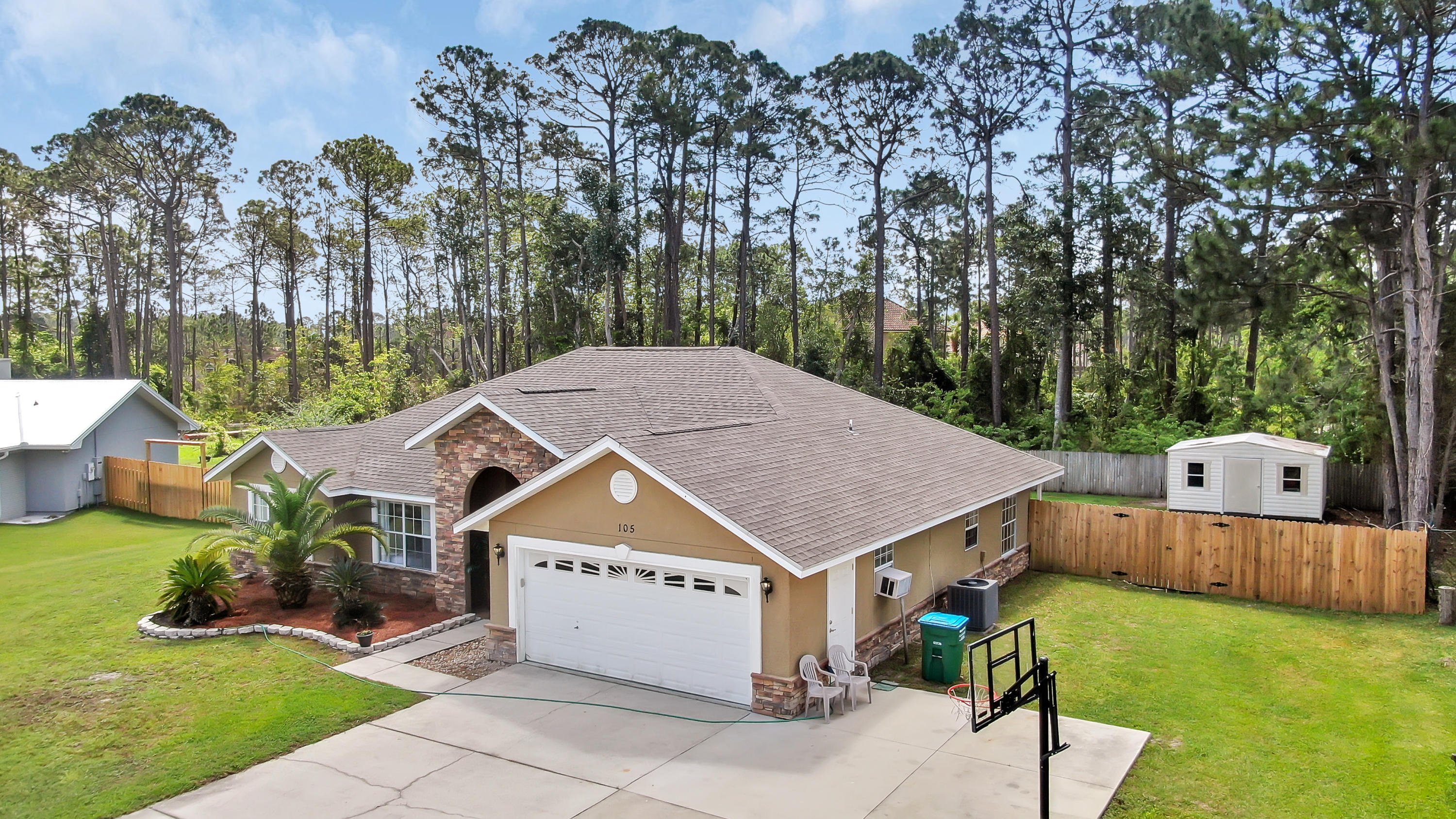 Beautiful 3BR/2BA Colony Club Home with great curb appeal. Located in the back quiet section of this fabulous Holiday Golf Course Community. NO HOA FEES. Two car garage with an AC unit in it. NEW FLOORING 2019. Painted inside. Extra large lot & back yard that backs up to a wooded area. Easily can fit any size pool, fire pit and/or playground for the kids. Don't miss your opportunity to live in this fabulous golf course community. Close to Pier Park Shopping & The World's Most Beautiful White Sandy Beaches & Emerald Coastline