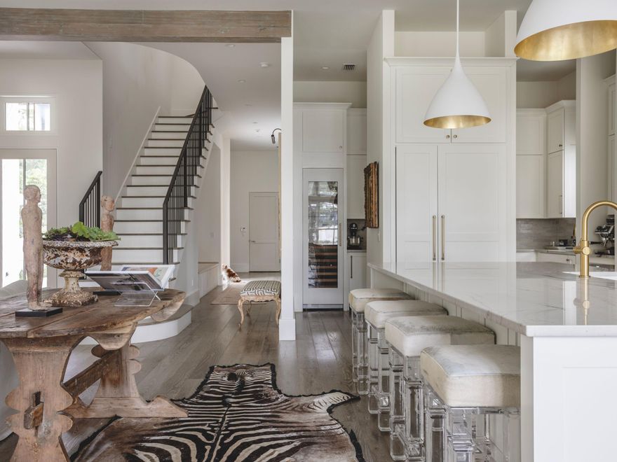 A masterfully designed retreat tucked away on a peaceful cul-de-sac in the sought-after gated community of Churchill Oaks, this residence is the personal home of a national designer who has artfully curated every detail to embody the essence of a life well-lived--a perfect balance of refined elegance, comfort, and effortless coastal living.Set on one of the most private lots in Churchill Oaks, with only one adjacent neighbor, this home offers an uncommon sense of seclusion and tranquility rarely found within the community. Designed by Matthew Savoie and constructed by Grand Bay Construction, this four-bedroom, four-and-a-half-bath home showcases timeless architecture and thoughtful functionality. Recently enhanced with custom wallpaper, designer lighting, and curated finishes, the interiors exude warmth, texture, and depthreflecting a home where beauty and authenticity coexist.

Expansive living areas with walls of glass overlook one of Churchill Oaks' tranquil spring-fed lakes, offering soft bay views and abundant natural light. The gourmet kitchen and auxiliary prep kitchen create a seamless flow for entertaining, while climatized wine storage and a dedicated home office provide both luxury and livability. A two-car garage and exterior parking for three complete this elegant and practical layout.

Set within 40 acres of waterfront serenity, Churchill Oaks offers an unrivaled coastal lifestyle with access to a private deep-water marina and a clubhouse featuring three pools, a fitness center, outdoor bar, media room, and spacious gathering areas for owners and guests.

A 31-foot deep-water boat slip with a newly installed lift and a 2023 Sea Hunt Gamefish boat are available for purchase, offering a rare opportunity to fully embrace the boater's lifestyle.

Every detail of 314 Tyler Drive has been thoughtfully designed to elevate daily livinga home that inspires, welcomes, and truly celebrates the art of creating a life well-lived.