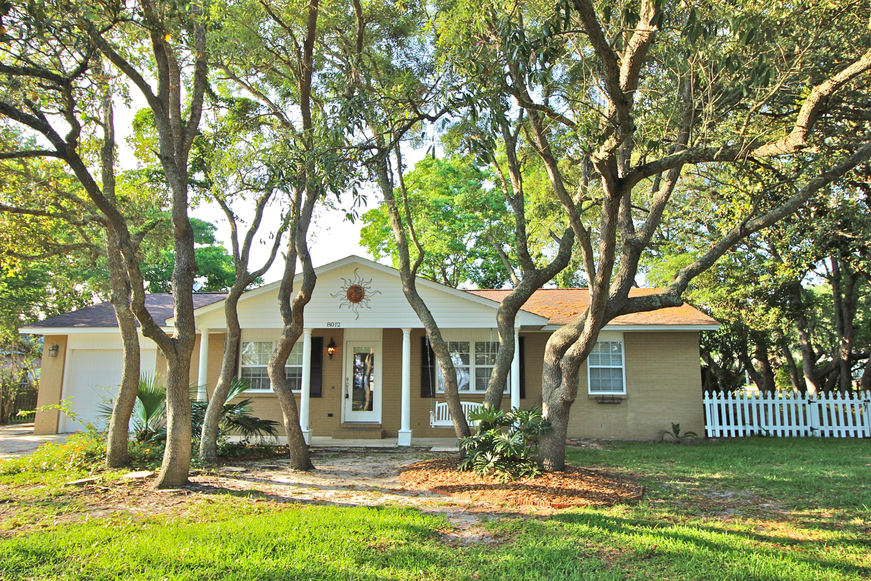 Sharp, uptown feel with character and charm is what you'll find in this remodeled home with front porch sound views plus deeded access; and in one of the most charming, quiet, walkable neighborhoods in Navarre, just blocks from Publix. Open concept living, kitchen, dining, all with beautiful saltillo tile. Or walk a few lots down to the deeded access & put in your boat or kayak. Screened back porch off dining & master w/ picket fenced side yard. Loads of shade from the hot FL sun allow you to fully use each space for family enjoyment & entertaining. Heated & cooled 1 car garage w/ back room with half bath (could be used as office, crafts, etc). Travertine shower in master bath & jetted tub in hall bath. Small yard for easy upkeep. Call for your private showing.