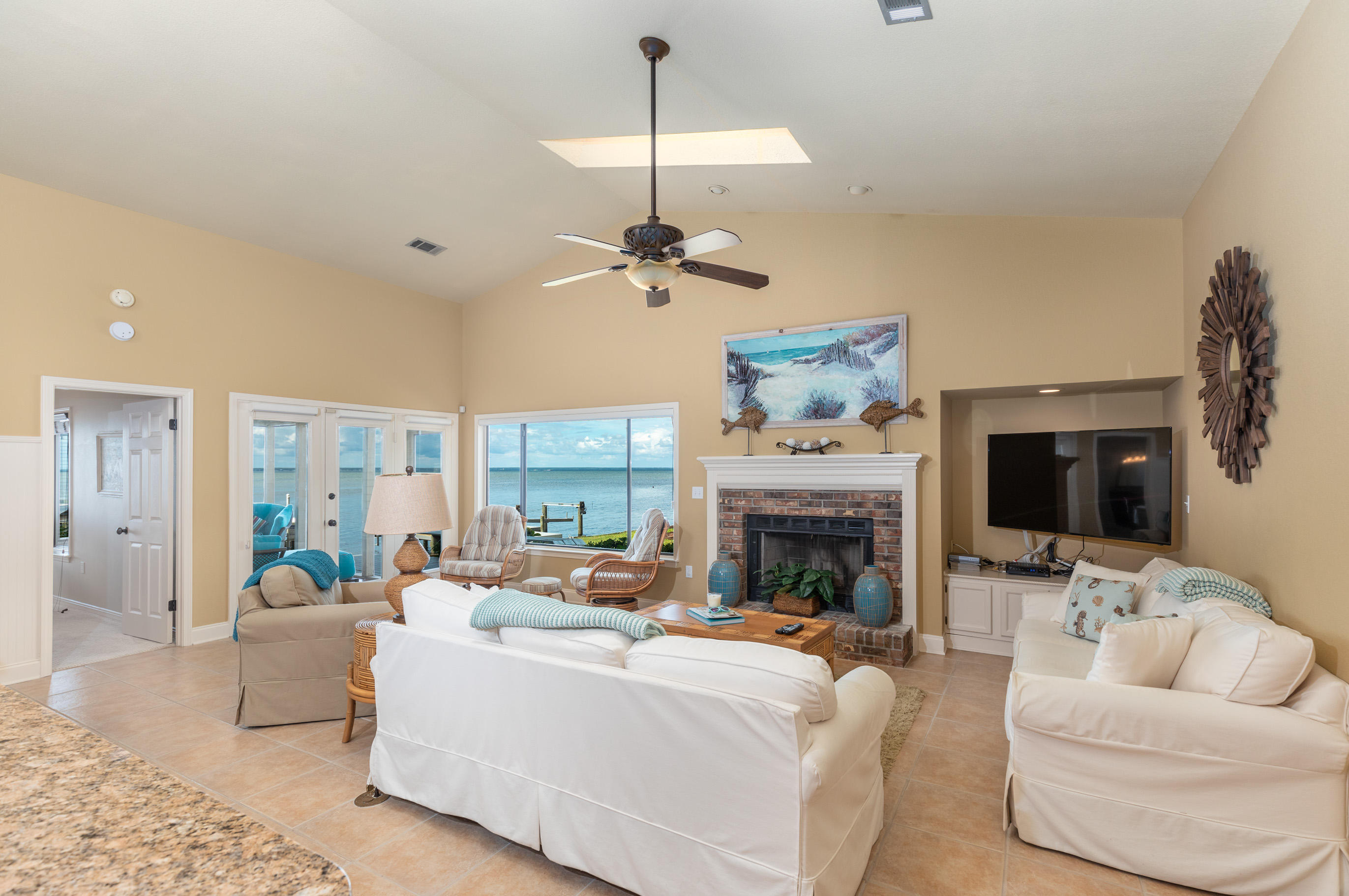 Situated directly on of the beautiful Choctawhatchee Bay, 162 Cove Dr is one a only a few homes that offers a combination of the bayfront living and access to the world class amenities of Sandestin Resort which include: beautiful beaches, 4 championship golf courses, tennis, marina, walking/biking trails, restaurants, shopping, live entertainment and more. As you enter this 3 bedroom 2 bath 1791 sqft all on one level home, you will immediately notice the 18 inch ceramic tile throughout the large open living area. The kitchen offers custom cabinetry, granite counter tops, stainless steel appliances, and oversized breakfast bar that opens to a huge great room with vaulted ceilings, and brick fireplace. Tons of natural light is provided by the skylights and bay windows that bring