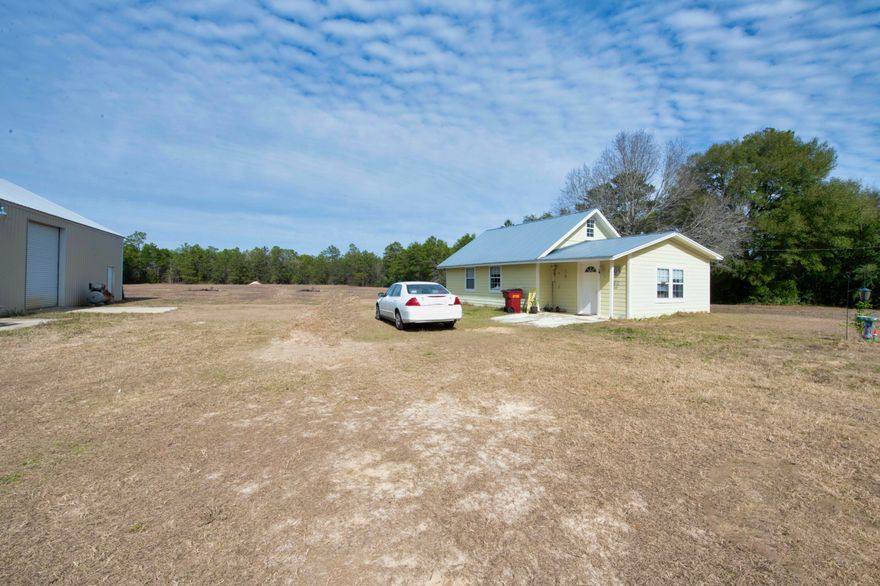 Enjoy 3 acres with this cozy 2 bedroom, 2 bath home with loft.  Tiled flooring throughout the home except the loft has carpet.  Plenty of kitchen cabinets, stainless steel stove and dishwasher. Large metal building with 2 bay doors 60' x 40'.  On city water and with septic system.  Approximately 250' of Hwy frontage and 517 deep. Home is being sold 'AS IS'.   Buyers are responsible to personally verify all details of the property and dimensions.  Any information contained in this listing is believed to be accurate but not guaranteed.