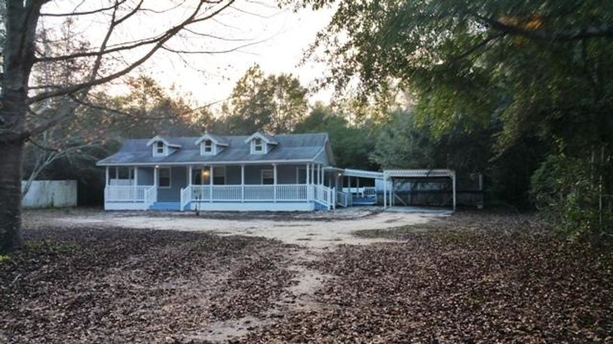 MOVE IN READY! This easy maintenance vinyl sided 3 bedroom and 2 bath home is situated on .49 acres just minutes from town. This country style home has a large 10 x 40 covered front porch and is nestled among a variety of trees adding to its charm. The home comes with all kitchen appliances and tile floors. A great starter home at a fair price for your family!