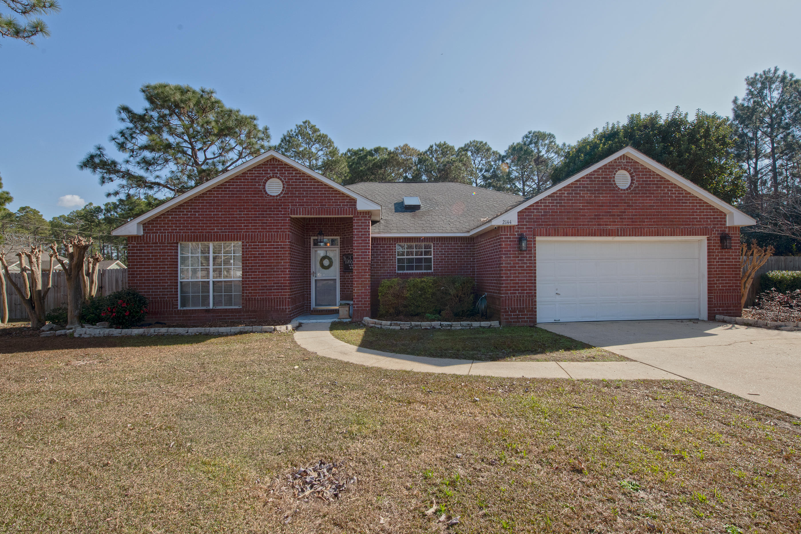 .Welcome to your new home in Navarre! This beautiful all brick home sits on a corner lot perfectly positioned in the sought after Holly by the Sea community. Relax knowing you're only 10 minutes from the beach and 20 minutes from Hurlburt Field. As you walk into your new home, you'll walk through your foyer and into your large open family room and kitchen with vaulted ceilings. Your kitchen has lots of counter space and a movable island. On your left side of your split bedroom concept home, you have two sizable bedrooms and full bath. To the right is your large master bedroom with a beautiful view of your back patio. Your master bath has two walk in closet, garden tub, and dual vanities. As you step outside into your Florida