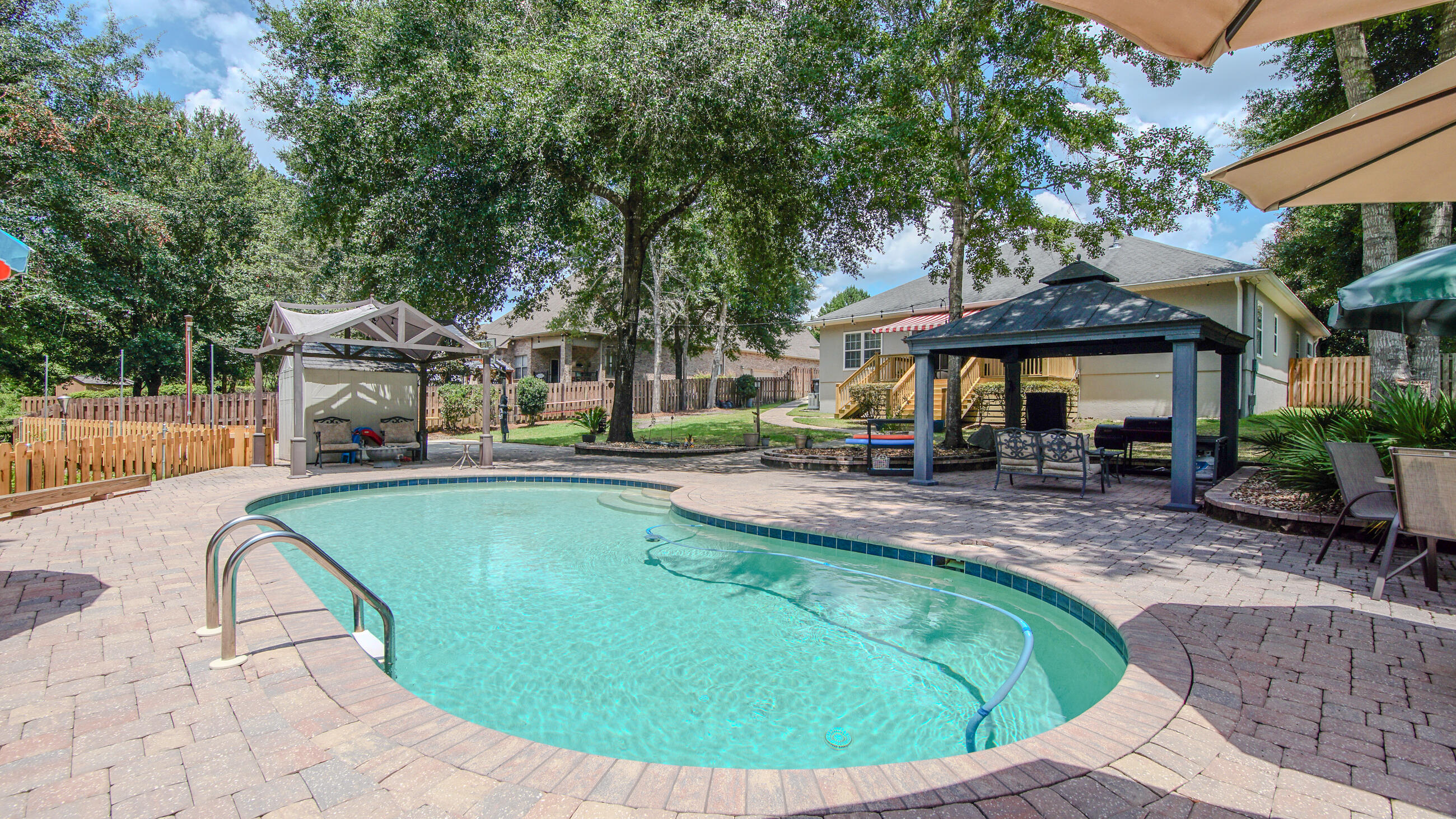 Welcome to 158 Whispering Way in the highly sought after community of Hammock Bay in Freeport! This stunning 5 bedroom, 3.5 bath home offers 2,824 square feet of beautifully maintained living space on an oversized .41 acre lot backing up to preserved land--meaning no rear neighbors, ever. The outdoor oasis includes a heated inground saltwater pool, brand-new deck, a basketball court, fully fenced backyard, and a backyard shed for extra storage. A whole-house generator adds peace of mind, while hurricane shutters, a new roof, and freshly repainted stucco exterior complete the upgrades. The HVAC system, replaced in 2020, is under a biannual maintenance plan for continued performance. Inside, you'll find a spacious and functional layout ideal for families or entertaining Whether you're relaxing by the pool, hosting gatherings on the new deck, or enjoying privacy and nature views from your backyard, this home delivers comfort, convenience, and long-term value. Built in 2008 and freshly updated - this one won't last long. Make an offer today!
Community Features: Hammock Bay is a master-planned, resort-style community offering exceptional amenities just minutes from the beaches of South Walton and 30A. Residents enjoy: Three luxurious clubhouses, two of them with its own pool and lounging areas. State-of-the-art fitness center, tennis courts, basketball courts, and miles of walking/jogging trails. A new General Store, event lawn, pickleball courts, dog parks, and playgrounds. Access to Lake Club amenities featuring a waterfront clubhouse and dock with views over the bay. Monthly community events and seasonal markets that make this neighborhood feel like home.