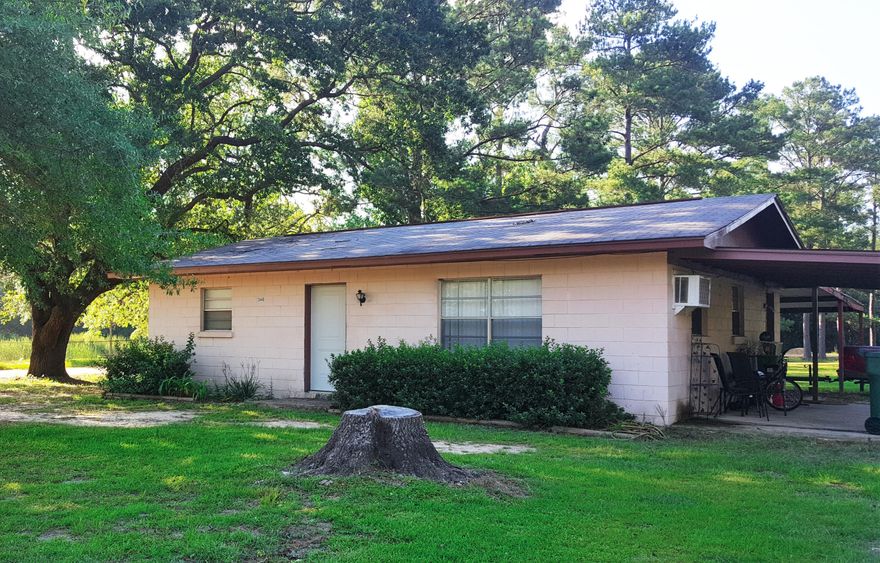 When arriving at this property you will immediately be impressed with the gorgeous lake view. From there, you will appreciate the attached carports and 2 pole barns that are included with the sale. Enter to find a well maintained home with a cute white kitchen, laundry room, and newer carpet and electrical. This property would be a great rental/investment property for you or an affordable place to live. If you want 2 homes, the adjoining home is available as well with the same layout and for the same price. Location is in the city...within 35 miles to the international airport and ''The World's Most Beautiful Beaches'' of Panama City Beach.