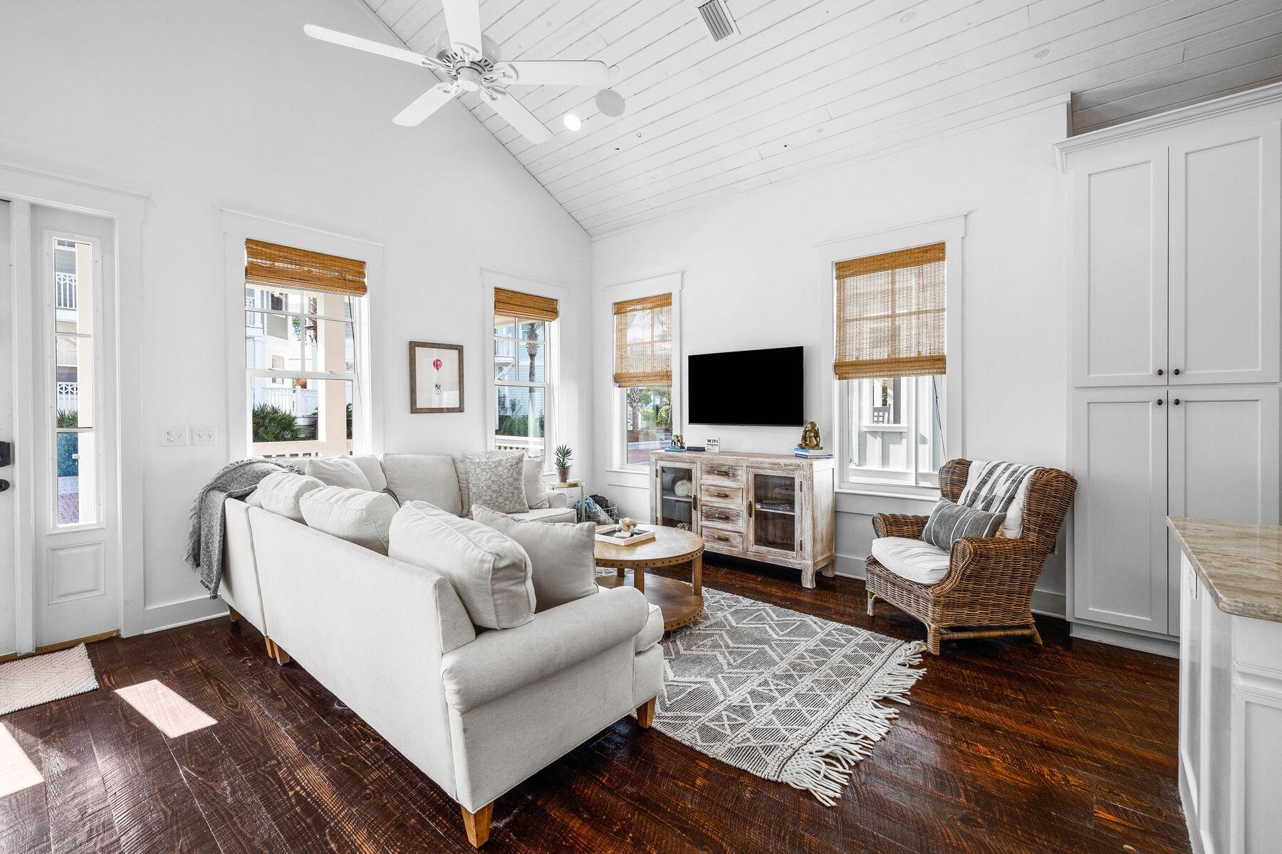 This surprisingly spacious beach cottage is perfect for laid-back luxury living, with shiplap and sliding barn doors adding a rustic touch to the coastal decor. The location could not be better, backing onto mature forest and a walking/bike path leading to Seacrest Beach amenities. The white sandy beach and 12,000-sq.-ft. community pool is conveniently close by, along with 30A shopping and dining. Plus, the home's walkability to the upscale shops, restaurants, and events in Rosemary Beach and Alys Beach means you'll have the best of 30A living right at your doorstep. This beautifully presented turnkey property is freshly painted and fully furnished. You'll feel at home the moment you step onto the front porch.Dark wood floors and a lofty vaulted ceiling add character, while a parade of tall windows cast abundant natural light into this bright, airy living space. The dining table easily seats eight for mealtimes and board games, while a lengthy window seat provides a natural space for kids to hunker down with their video game console. Indulge your culinary passions in the open-concept kitchen, which has everything you need to cook and entertain. A center island showcases a beautiful yet practical granite counter with a butler's sink and breakfast bar seating for three.
Two king-size master suites are on the main floor, along with a spacious twin bedroom. One of the primary suites has a small private balcony for quiet times, and all have lavishly appointed bathrooms. Stairs lead down to a basement level complete with a laundry room, media room, and a custom bunk room to sleep four. Imagine cozy evenings curled up on the sofa watching your favorite movie after a fun day of swimming, shelling, and dolphin spotting. French doors can be opened wide to provide a seamless transition onto the rear covered porch for barbecues and social gatherings. There's ample space for lounging and reading in the sun, with mature greenery providing ample privacy.
Located in the heart of Seacrest Beach, this four-bed, four-bath home is conveniently close to a walking/biking path, making it easy to spend time at the nearby lagoon pool and the endless white sandy beach. Whether you're looking for a peaceful luxury retreat, a family vacation home, or a rental opportunity, this versatile home checks all the boxes.