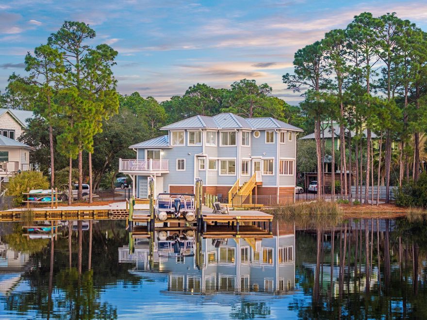 Nestled along the shores of Eastern Lake, one of South Walton's rare coastal dune lakes, 120 Shannon Drive is a waterfront retreat offering stunning sunset views and expansive lakefront scenery. Located on a quiet cul-de-sac in Seagrove Beach along Scenic Highway 30A, this home provides direct water access with a private dock and boat lift, allowing for kayaking, paddle boarding, and boating straight to the beach, where you can pull your boat onto the sandy shore and carry your chairs and beach gear for a day of relaxation. Designed for comfortable and inviting waterfront living, this four-bedroom, two-bathroom home features an efficient open layout with large windows that maximize natural light and lake views.  The kitchen is well-appointed, offering high-end appliances, quartz countertops, and custom cabinetry, all flowing into the living and dining areas for an easygoing, functional space. The primary suite provides a peaceful lakeside retreat with expansive water views and an en-suite bath featuring a jetted tub, walk-in shower, and dual vanities.

Outdoor living is a highlight, with a spacious back deck that seamlessly connects to the newly built, oversized dock, perfect for enjoying lakefront sunsets and entertaining. The sandy backyard blends naturally with the lakefront setting, and the fenced yard offers convenience for pets.

Offering low-maintenance coastal living, 120 Shannon Drive is a rare opportunity to own a true lakefront retreat with direct Gulf access.