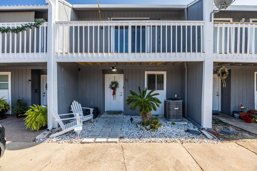 Welcome to Destin Racquet Club Townhomes, where comfort meets style in a prime location. This beautifully updated 2-bedroom, 2.5-bath townhome boasts modern features and elegant finishes throughout. The spacious kitchen is a chef's dream, featuring stunning granite countertops, white kitchen cabinets, a sleek stainless steel undermount sink, and high-end stainless steel appliances. Downstairs, you'll find a convenient half bath and a laundry room, complemented by luxurious LVP flooring and a charming white-washed stone fireplace.Upstairs, both bedrooms offer private balconies and en-suite bathrooms for added privacy and comfort. The front bedroom is highlighted by a walk-in, fully tiled shower and a white vanity with a granite countertop and undermount sink, creating a spa-like atmosphere. The back bedroom features a tub/shower combination, with a matching white vanity and granite countertop with an undermount sink.

Step outside to your backyard, which includes an open area with a covered patio perfect for relaxation or entertaining. The community offers a refreshing pool for residents to enjoy.

Located just 3 miles from the stunning beaches of Destin and 2 miles from the vibrant shopping and dining options at Destin Commons, this home offers the perfect balance living and easy access to local attractions. For golf enthusiasts, the Destin Racquet Club Townhomes are just 4 miles from the famous Sandestin Golf and Beach Resort. Additionally, the famous HarborWalk Village, offering waterfront dining and entertainment, is a short 5-mile drive away. Whether you're lounging at home or taking advantage of the neighborhood's pool, this Destin Racquet Club Townhome offers the ideal blend of luxury and convenience.