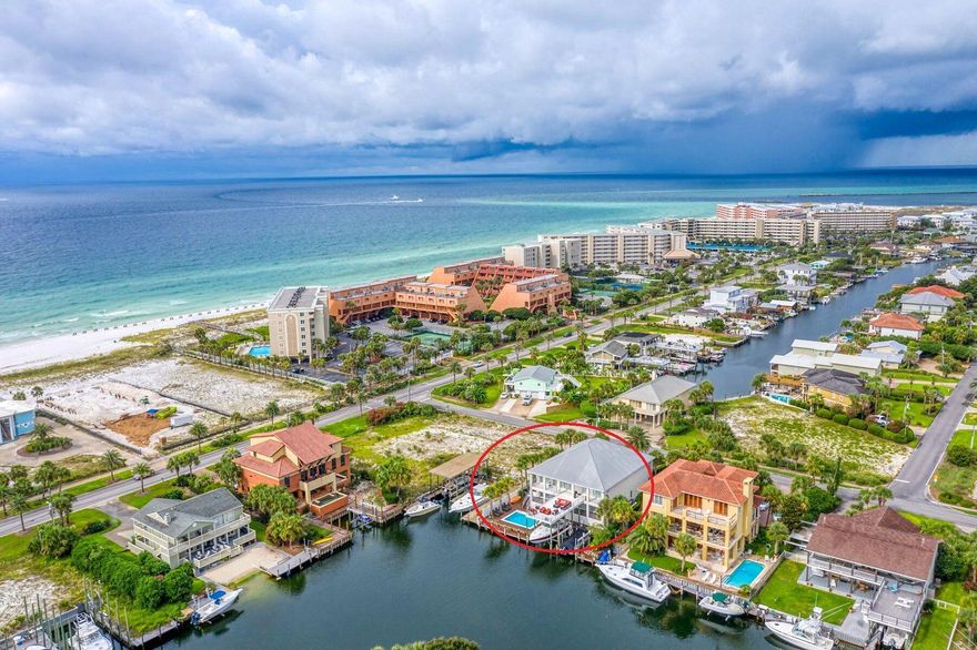 150 Steps to Beach Access & 10 Min Boat Ride to Crab Island! Welcome to 4 Norriego! A one of a kind, floor to ceiling custom modern home that sits perfectly in Holiday Isle with commanding canal and gulf views.RENTAL PROJECTION $262,500! This stunning glass and steel architectural modern home consists of 6 beds, 5 full baths, and 2 half baths and is being sold FULLY FURNISHED!Two stories with views and sunlight from every room, this is an entertainer's dream! You will love the open floor plan with two top of the line grand chef's kitchens, two large living rooms (1st floor equipped with a custom shuffleboard and direct pool/boat access), two water front King Master Suites, a pool and two boat lifts!