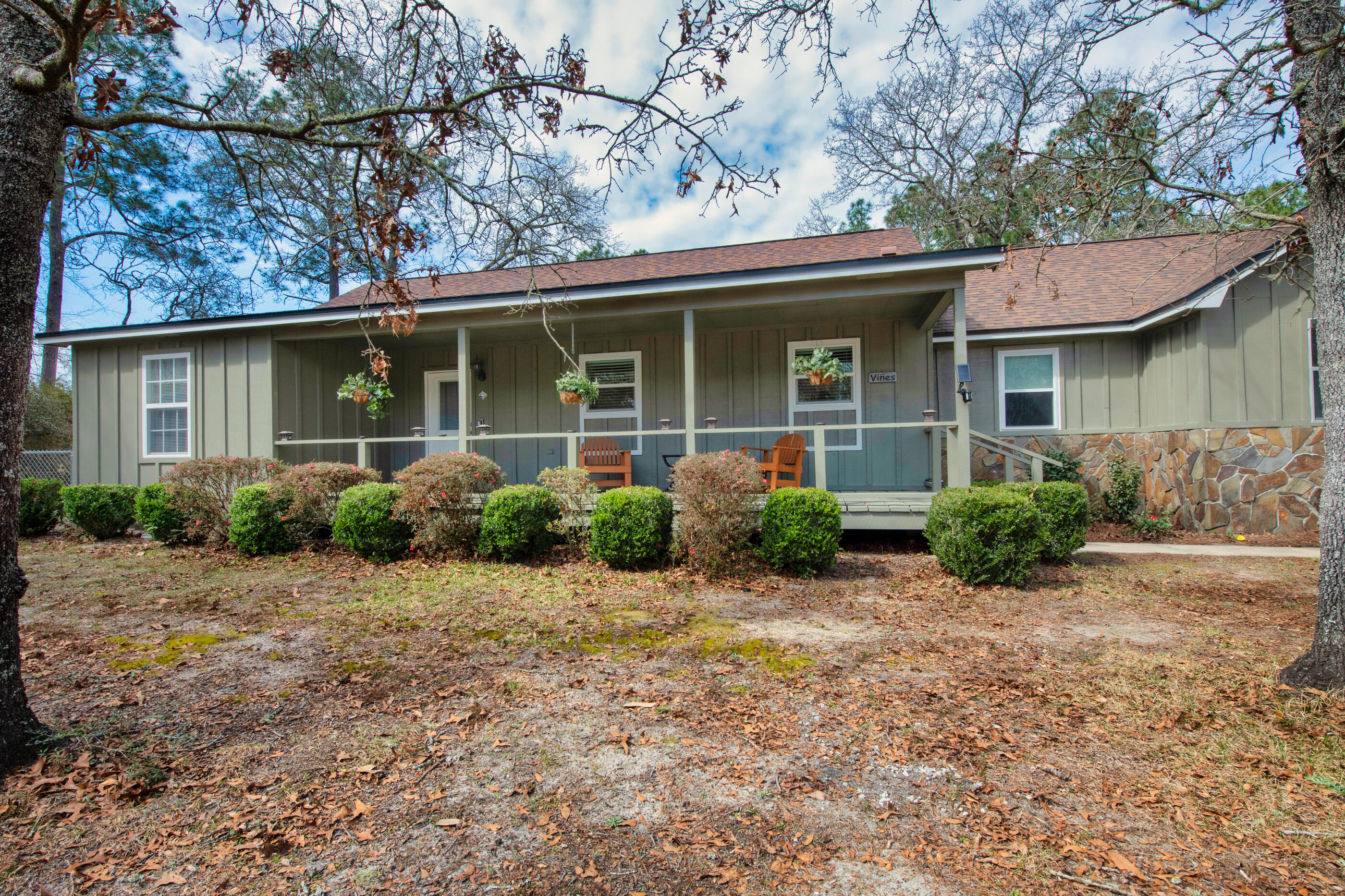 This is a beautifully RENOVATED Craftsman-style farmhouse with impressive UPGRADES, perfect for family living or those who love a peaceful, countryside lifestyle. With over $100,000 in improvements, this home has been thoughtfully updated, featuring NEW ENERGY EFFICIENT WINDOWS AND DOORS, NEW LVP FLOORING, A 2-STAGE HEAT PUMP A/C system with new ductwork, and more.The house welcomes you with a charming Southern porch ideal for relaxing with a glass of sweet tea. Inside, the home offers richly stained woodwork, vaulted and beamed ceilings, and a cozy stone fireplace. The NEW FAMILYSTYLE KITCHEN is a dream for any home chef, featuring white shaker cabinets, a stainless steel appliance suite, and expansive countertops perfect for cooking and entertaining. The spacious master bedroom can accommodate large furniture, and the newly renovated master bath includes dual vanities and a modular walk-in shower. The remaining bedrooms are generously sized, and the split floor plan ensures privacy.
For those who enjoy the outdoors, the sunroom is flooded with natural light and overlooks a large backyard full of beautiful landscaping, including a mulberry tree, gardenias, and raised garden beds. If you're an avid gardener or enjoy outdoor activities, there's even space for chickens! The covered patio offers room for BBQs and outdoor seating.
A standout feature of the property is the large 19 x 32 WORKSHOP WITH ELECTRICITY an additional 12 x 12 storage room, and covered outdoor storage space that can accommodate up to four cars. Whether you need a workshop, additional living space, or just extra storage, the possibilities are endless.
Situated in the COUNTY, you'll enjoy LOWER TAXES, adding even more appeal to this charming home. With all these upgrades and features, what are you waiting for? Make an offer today and move into your dream farmhouse!