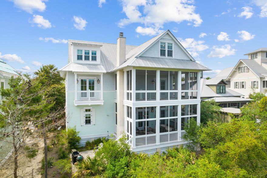 New Photos. Positioned in the coveted Lake District this coastal retreat overlooks a nature preserve with  a huge two story screened porch. All the privacy of Phase III with an easy walk over the bridge to the town center and the beach. Buyers who want to experience the ultimate in vacation amenities will appreciate this large home with a carriage house that boasts a two-story screened porch ideal for enjoying Florida's outdoor lifestyle while primary owners would appreciate the two-car garage and exceptional finishes and coastal palette in this upscale home. The open floor plan incorporates a remarkable gourmet kitchen, large gathering areas and dining room that opens to the outdoors with a fireplace, TV and ample seating. Two primary bedrooms are available on the first and second floors A large third-floor living and sleeping area is ideal for children and teens with built-in bunks and areas for both gaming and enjoying movies. Enjoy hardwood flooring, shiplap, marble and tile throughout this fully-furnished home. The carriage house offers its own private balcony, kitchen and full bath. There's no shortage of things to do in WaterColor including the beach, pools, trails and paddle boarding as well as the WaterColor Beach Club and Camp WaterColor and a host of dining, shopping and entertainment options. After a day in the sun, gather with family and friends at home for a quiet cocktail or get together on the beach for a bonfire complete with s'mores.