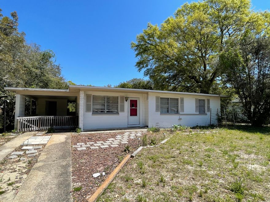 Located in the heart of Fort Walton Beach, this 1272sf all block home was built in 1955, but has had updates in the past. Home has 3 bedrooms and a full bath. The back yard is fully fenced and there is a detached garage/workshop as well as an attached carport area that could certainly be converted into additional living space or an attached garage. Kitchen and living room are an open floor plan and there is an additional room at the back of the home. This home needs some work and will not qualify for most financing.