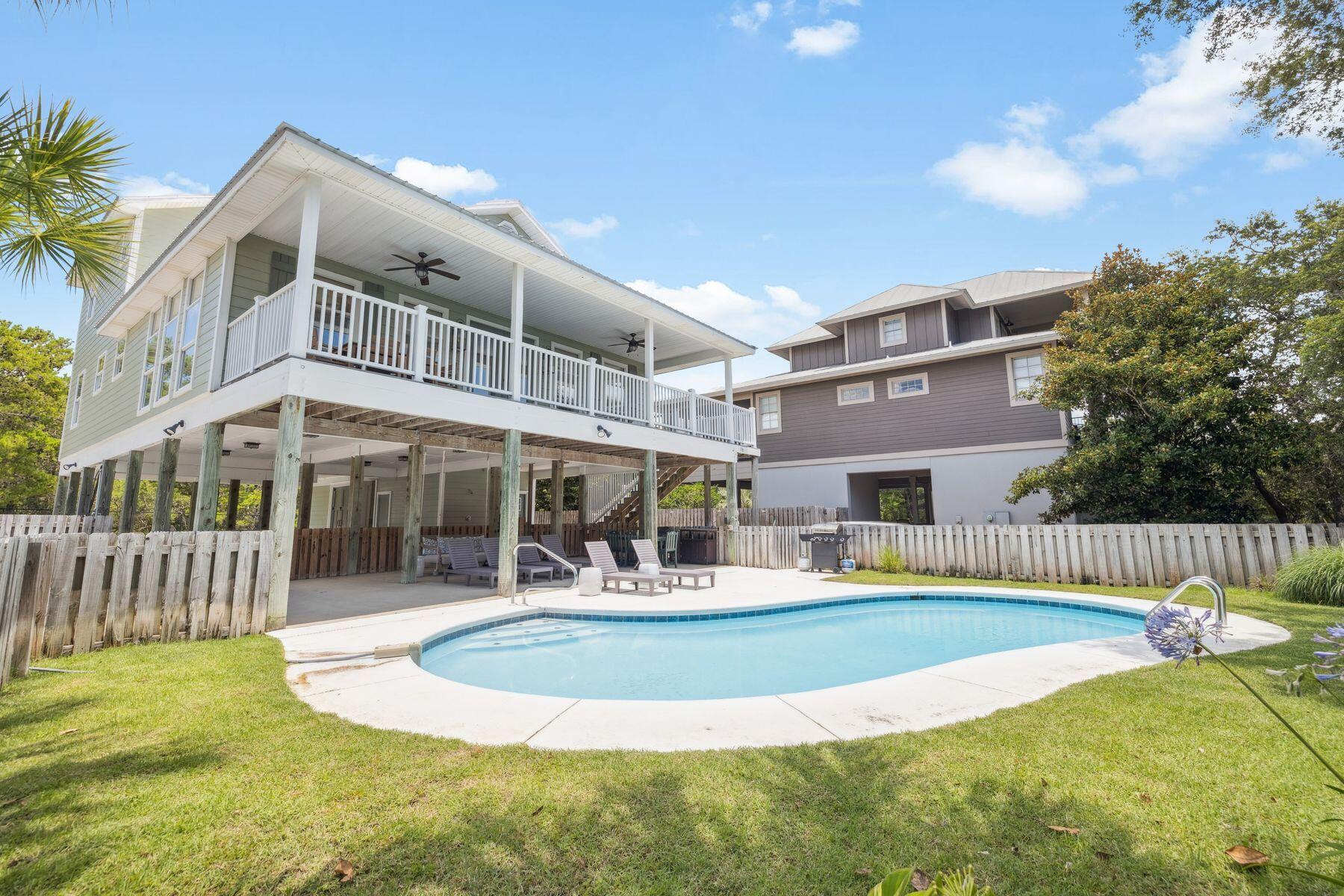 Gulf Trace is a highly sought-after, established community on the south side of 30A, known for its spacious lots. A beautifully renovated home features four spacious bedrooms, including added bunk beds to comfortably accommodate additional guests. Thoughtfully designed by one of the owners--an interior designer--it offers a warm and welcoming retreat after a day on the white sand and emerald waters. The open concept living, dining, and kitchen area is enhanced by a vaulted wood ceiling, creating a cozy, coastal ambiance, while the large private pool adds the perfect touch for relaxation and fun The first level includes a functional mudroom and laundry area--perfect for storing beach gear or day-to-day essentials. Easy Parking for 5 vehicles Upstairs on the second level, the main living area impresses with vaulted ceilings, abundant natural light, and a calming palette of soft greens. The spacious kitchen and dining area are well-suited for hosting, with seating for ten and additional space at the peninsula. A large balcony off the living room offers views of the pool and cool coastal breezes. The home offers four well-appointed bedrooms across the second and third floors, each with its own en-suite bathroom, creating an ideal layout for families or guests. Whether you're looking for a primary residence, second home, or investment property, this home combines thoughtful design, quality finishes, and an exceptional location in one of 30A's most beloved beach communities."
