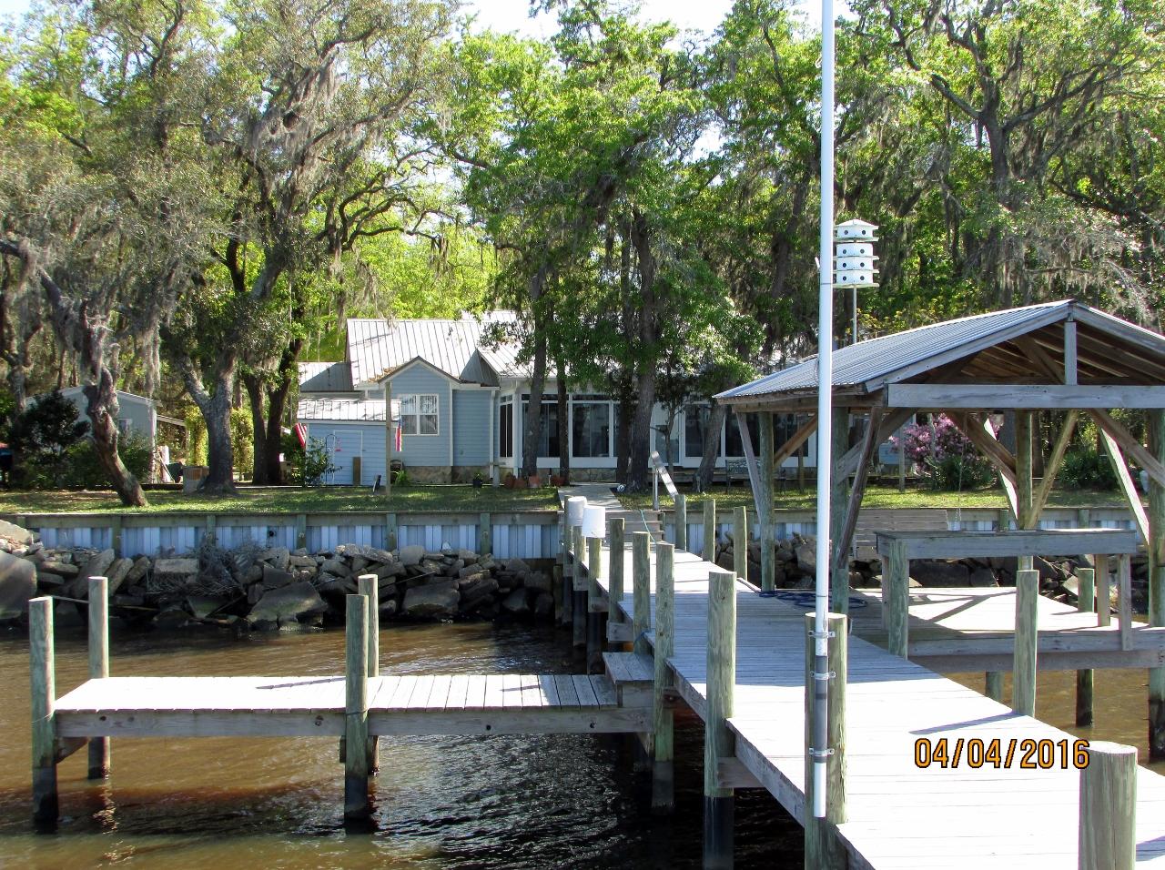 A rare find!!! 125 feet of gorgeous bay frontage off of Chat Holley Road.This property is beautiful and pristinely maintained. If you are looking to be close to everything, this is the place- close to Highway 331, highway 98, Destin and Panama City Beach. A very short trip to the Beaches of South Walton! The property boast a deep water dock with a typical low tide depth of bay at dock is 2-3 feet (per seller). The dock stretches out 100 feet from shore, it has electricity, and a covered area with sink a few feet from shore. The fortified seawall has deep pilings and cable holding seawall in place, along with large pieces of broken concrete in front of seawall to further protect the property. Properties on either side of this property,have seawalls as well.