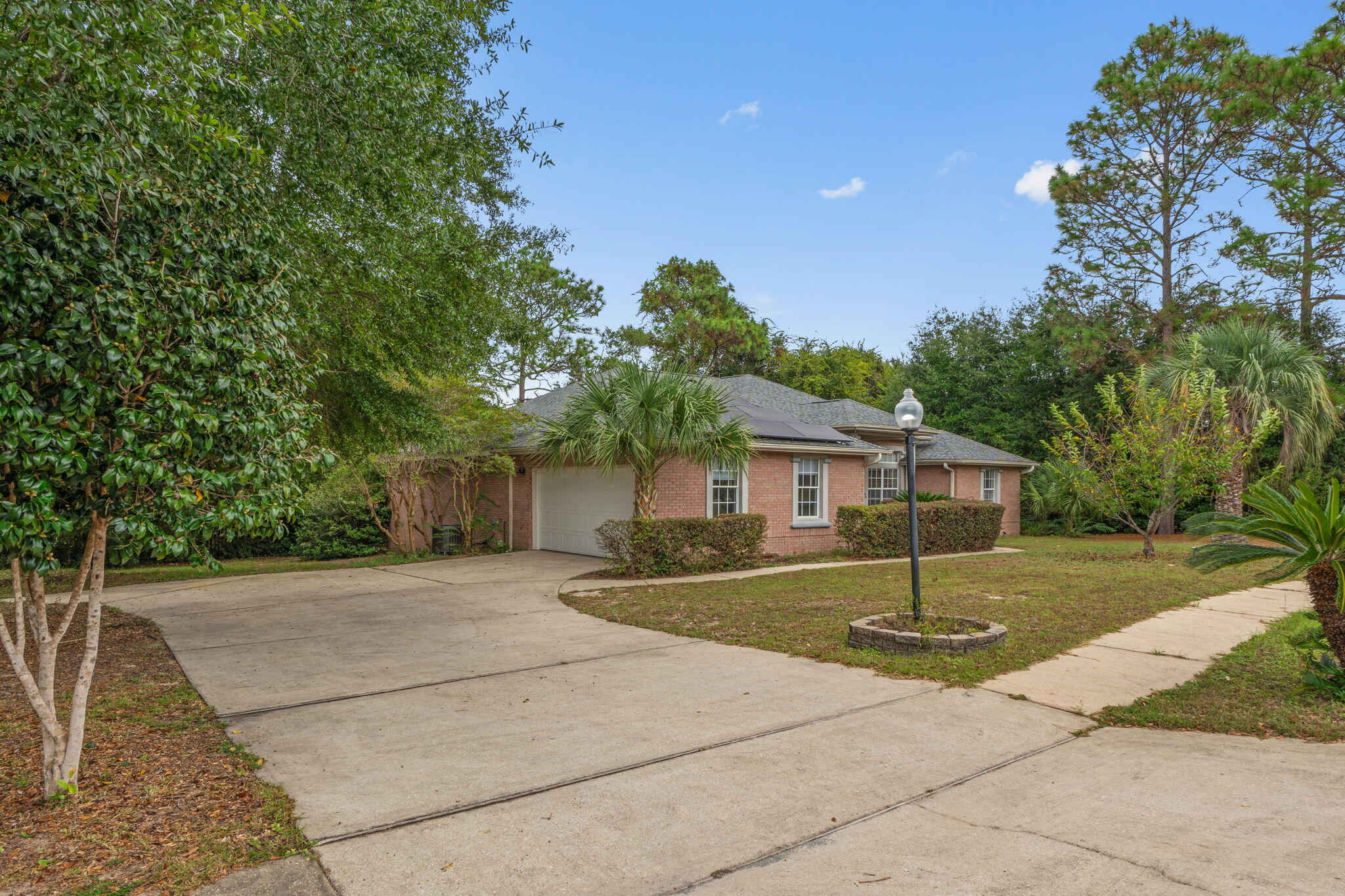 Step into a home where all the major systems have already been taken care of, ROOF (2020), HVAC (2020), and septic drain field (2020) Enjoy low energy bills with paid-off solar panels. Inside, you'll find a split floor plan design. Large owners suite offers a relaxing retreat with a spacious bathroom, guest suite with its own private bath. Down the back hallway, two additional bedrooms and a full bath. The home features a formal dining room and a dedicated office space complete with floor-to-ceiling built-in bookshelves with a rolling ladder, ideal for a cozy reading nook. Step outside to a screened-in back porch overlooking a flat, tree-filled lot that offers shade, privacy, and natural beauty. The community features a park and pool. This home is full of character, potential, and value.