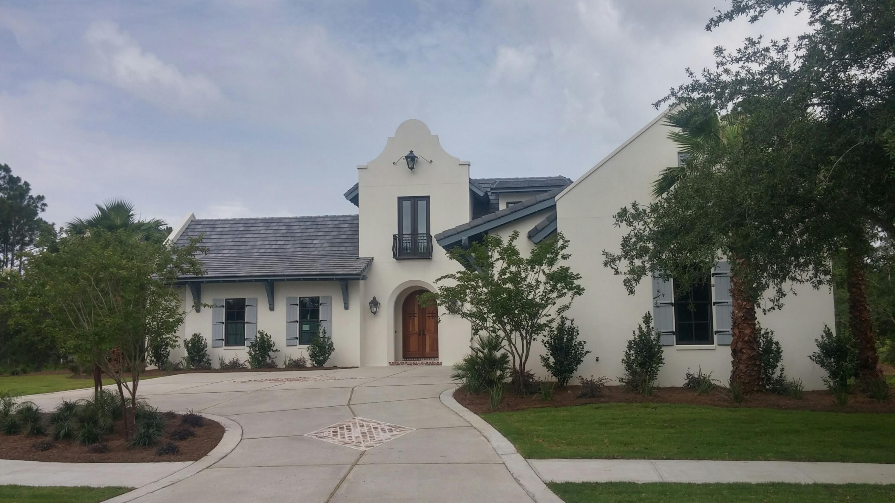 New Custom Home on lake and golf course at Burnt Pine. Stunning white masonry home inspired by the architecture of Bermuda and Antigua. Home has 3 bedrooms, 3.5 baths, office, and 3 car garage. Spacious open floor plan for the Living, Dining, and Kitchen area. Gourmet kitchen has grey cabinets with taj mahal quartzite countertops, Sub Zero Refrigerator, 48'' Wolf double oven stove, Bosch dishwasher, ice maker, refrigerator drawers, and large walk in pantry. Other features include wire brushed hardwood floors in the entire house, beamed ceilings in living room and master bedroom, bricked arched walls in foyer and kitchen, large walk in master closet with custom shelving and custom bathtub in master bath. Great screened porch with brick floors overlooking the lake, golf course, and courtyard
