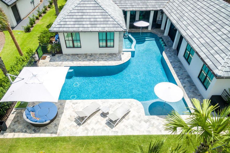 What an amazing home and pool area !!! Newly built, this exquisite custom built by Huff Homes overlooking The Raven Golf Course is a rare find. Thoughtfully designed and meticulously maintained, 3956 is a desirable single level home complete with a separate guest house and state of the art outdoor living space and pool. Exterior features include over sized ozone heated and cooled pool with swim up bar for 4 and a10 person hot tub with waterfall and wall mount fire torches. The summer kitchen and outdoor living space were built for Florida living with a SubZero refrigerator, 4 ft gas grill, outdoor shower, pool bath, fire pit and high top table bar. The interior is spaciously designed with 5 bedroom, 4 full bath, with 3 additional half bath.
