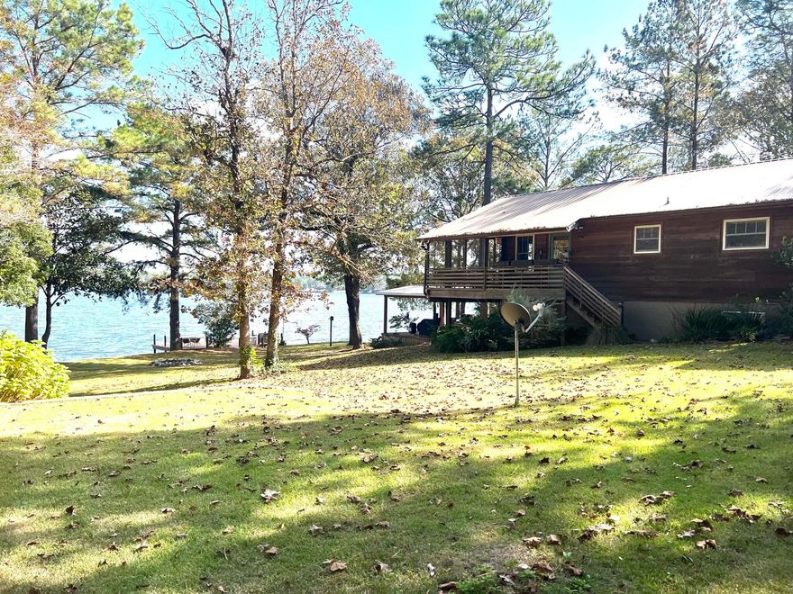 Rare find on this Lakefront beauty in desirable Spring Lake Estates! This renovated cabin has some of the most beautiful lake views you can imagine from the main floor, as well as the walkout basement. Main level has 2 BRs, 1 bth, open floor plan, vaulted ceiling & FP in living room, cozy kitchen & dining area. A 10x30 screen porch spans the entire lakeside of home. Walkout basement has the master BR, w/ sitting area, generous family room, laundry, addtl. multi-purpose space...& more amazing lake views from inside, as well as a concrete patio leading out to the lake. On the way to the lake, you can fire up the grill on the 16x16 gazebo before heading to the dock or private boat launch to catch your meal for the day! Circle drive for easy covered parking for RV & autos. BACK UPs CONSIDERED!