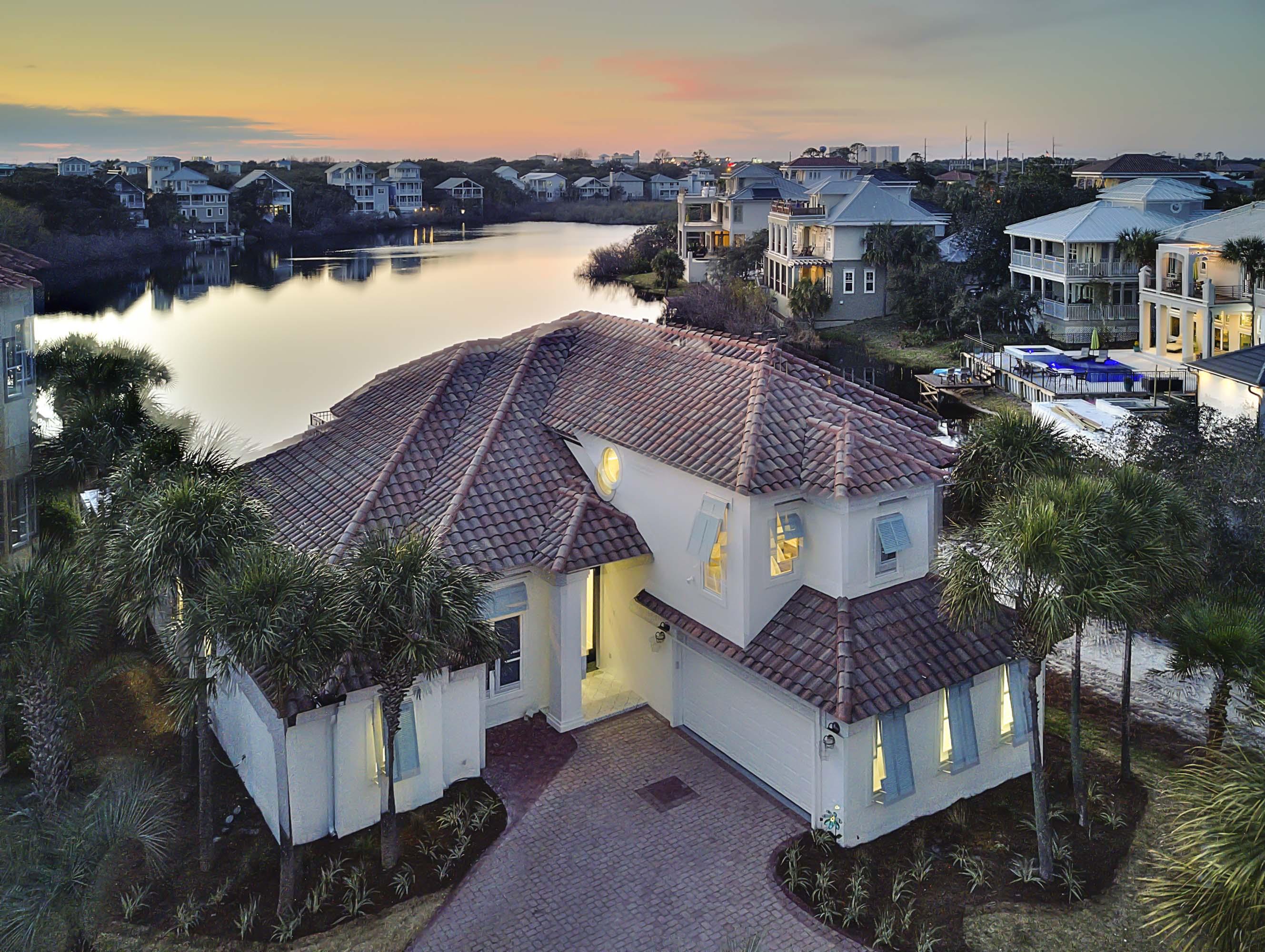 This casual coastal contemporary home seamlessly blends serenity and elegance into this beach-side lake front residence. It's perfectly situated two tiers off the Gulf of Mexico in the gated community of Destiny. In 2018, this home received a complete transformation by Coastline Luxury Homes with professional interior design & tastefully appointed furnishings. This home features 5 bedrooms, plus a bunk room, 4 full bathrooms and a large open floor plan with clean lines and pristine lake vistas. This lake front retreat is ideal for large families or an exemplary investment opportunity with over $200,000 in projected gross annual rental income for 2019.....