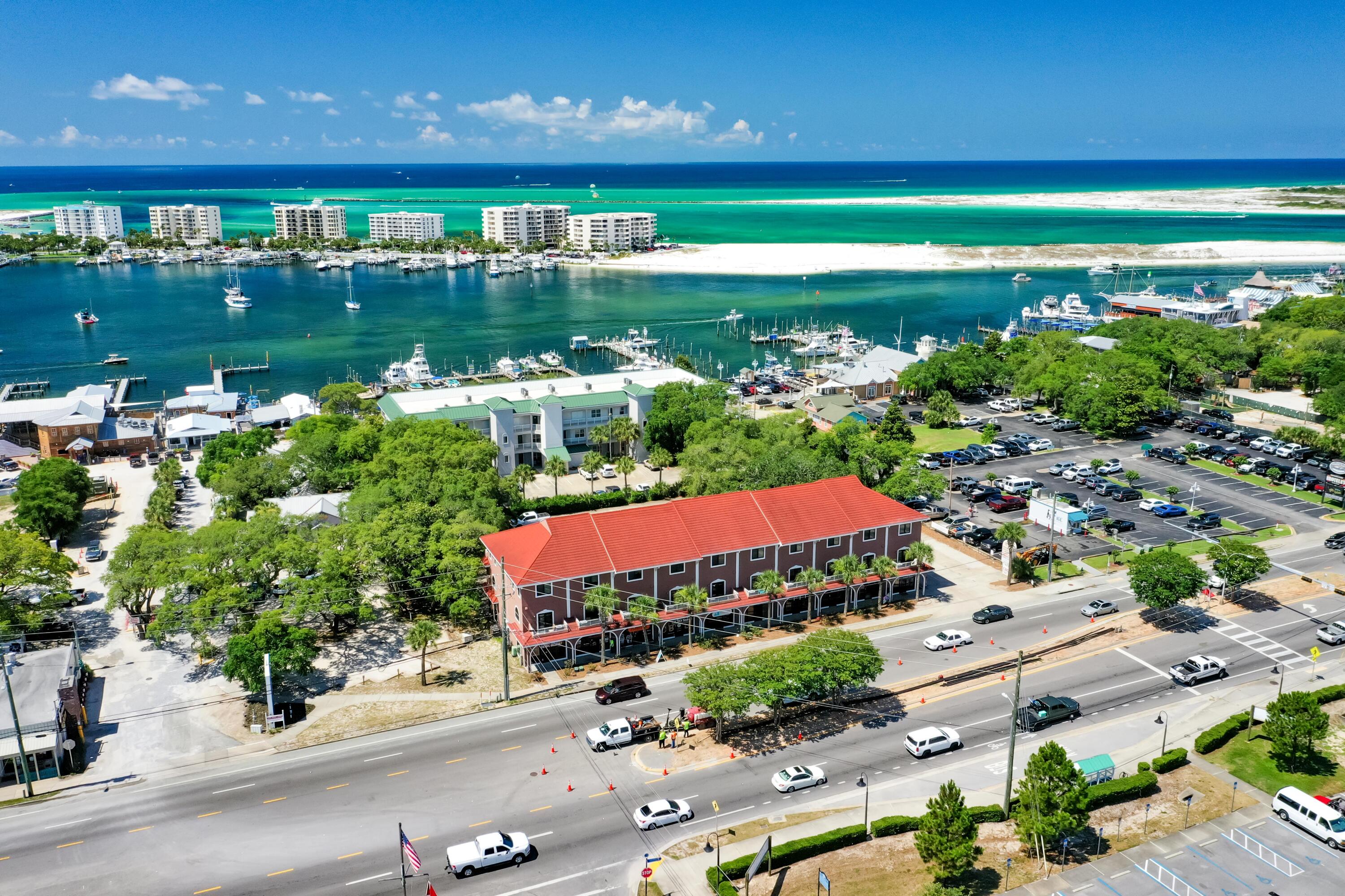 This entire building is offered for sale, which is located on the South side of Harbor Boulevard in Destin, Florida, encompassing (10) contiguous commercial retail storefront units, each measuring +/-600 SF, in addition to (10) two-story apartments, each measuring +/-1,400 SF with 2 bedrooms and 2.5 baths, featuring front and rear balconies.  The strategic location of the site creates exceptional synergy from patrons walking across Harbor Boulevard from one of the City of Destin's largest public parking lots, which is located on the North side of Harbor Boulevard with a pedestrian crossing directing... visitors to the retail storefronts of this subject venue, known as Harbor Village.   The entire building has been renovated. The site contains nearly 1-acre, approximately 220' of Highway 98 (aka, Harbor...Boulevard) frontage, and a total of (56) parking spaces.  Each of the (10) separate deeds include (1) commercial retail storefront and (1) residential apartment atop the commercial space, both offering independent access, thus allowing for two different tenants in each of the units; in other words, the building in entirety could host (20) different tenants.  The City of Destin zoning is known as South Harbor Mixed Use (SHMU).  Please refer to the zoning fact sheet that is uploaded to this listing. Please inquire for further information and to coordinate a private showing.