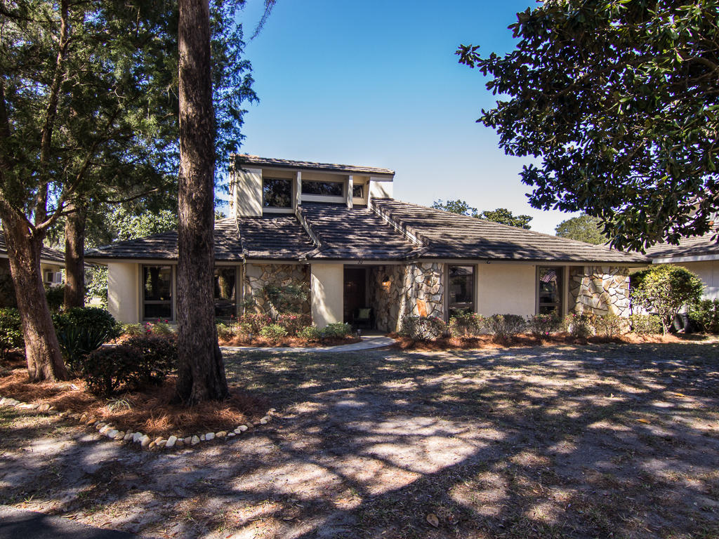 Beautiful lakefront home in highly coveted Bluewater Bay neighborhood, just beside the Golf Course Clubhouse! This 2 bedroom, 2.5 bath home is nestled on the water, with fairway views and in close proximity to the golf cart path. As you enter the house, you walk into a spacious living room, complete with vaulted ceilings, a wet bar, hard wood flooring, and a gas fireplace. The eat-in kitchen boasts tile flooring, granite counter tops, a flat cooktop stove, newer appliances, and there is also a formal dining room!
