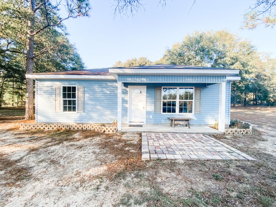 This completely updated 2 bedroom, 1 bathroom home would be the perfect starter home! With the open floor plan in the kitchen and living room, it makes the home appear much larger. The oversized laundry room off of the kitchen could also double as a pantry. The carpets have been replaced throughout the entire home. The HVAC unit was also replaced. The best part of this home is it comes with almost 4 acres with highway frontage on Sunrise Road! There are two barns/sheds out back and with a little bit of love, these would be the perfect workshops!