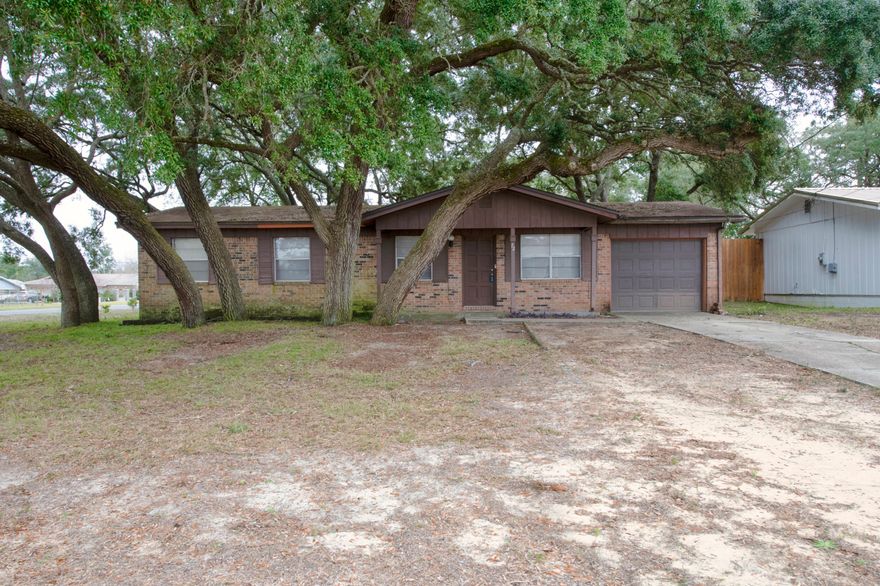 OPEN HOUSE Sat, 1/8 from 11am-2pm. Four Bedroom, 2 bathroom home on corner lot with mature trees, outdoor brick fireplace, and an opportunity to make it your own. Eat in kitchen/dining area, living room, several closets for storage and attached garage with laundry area and  above garage attic storage. Master bedroom has en suite bathroom.  3 additional bedrooms share another full bathroom w/tub. All information deemed important to be verified by buyer.