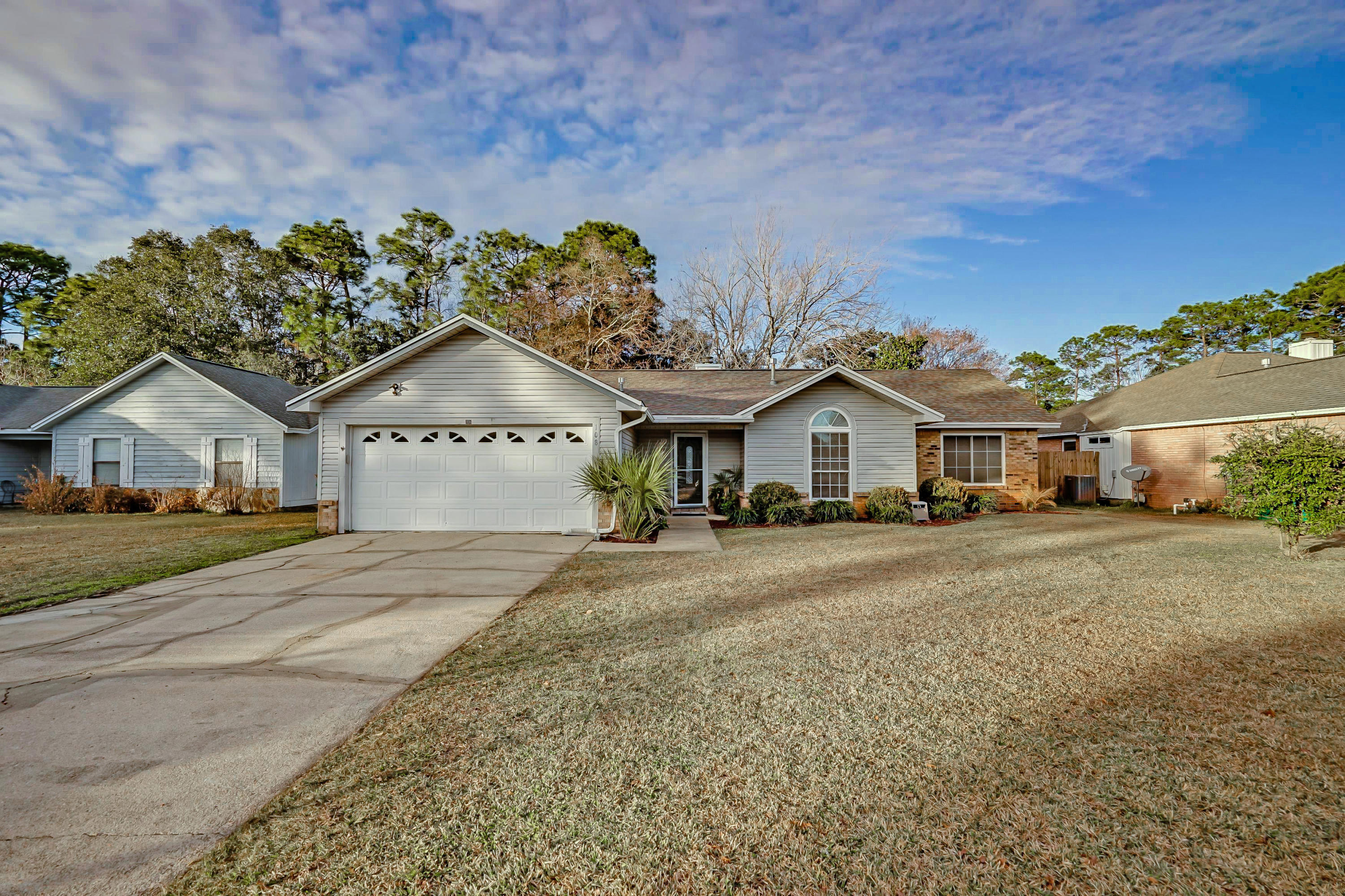 Fantastic home in Meadow Woods subdivision with a large back yard. Inviting family room with a fireplace and cathedral ceiling, spacious kitchen with a breakfast bar and large dining area. Master suite has an updated master bath with travertine tile and vessel sinks. Laminate and tile flooring throughout, no carpet. Brick and vinyl siding make for easy maintenance. This home is not only in an A rated school district but is also just a ten minute drive to the beautiful beaches of Destin. Easy commute to Eglin, Duke and 7th Group. Don't miss out on this lovely home, call today to schedule your appointment to see it.