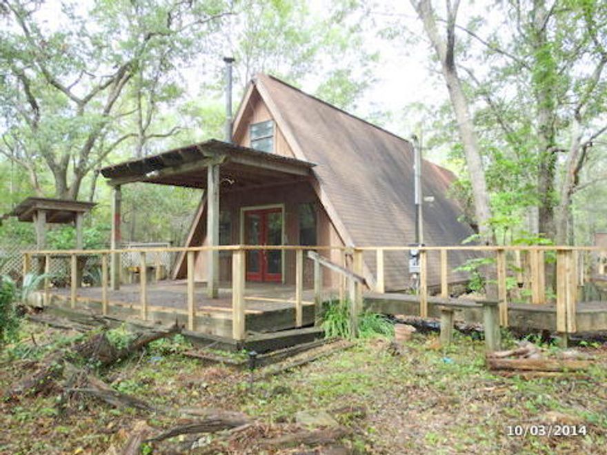 Adorable A frame home sits on a large lot. This home has a sitting around, small kitchen, loft sleeping area, and screened porch. With repairs and vision this can be a unique property and it is very affordable. Sold as is. All information is approximate.