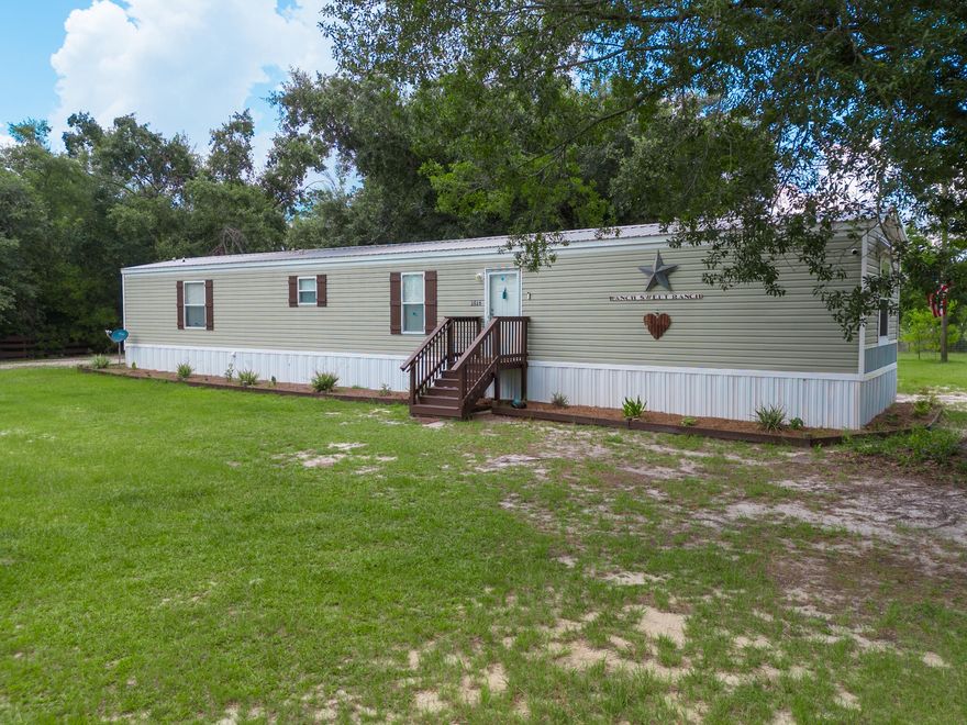 This equestrian estate is turn key and  ready for your horses!  Situated on 3.3 acres,  this property is zoned R2 which allows up to 4 dwellings.  The newer mobile home is farmhouse style with a split bedroom plan, and Jack/Jill bathroom between the other two bedrooms.  The 36x38 barn is equipped with 4 stalls and also allows room for hay storage and equipment.  Located on the property are another 2 storage buildings, 10x20 unit near the home and is currently used as a tack room as well as a larger 14x20 shed at the end of property.  There is also a spring fed pond and a covered 12x12 feeder.  This parcel is on city water but there is a well used for the animals.  Tyndall AFB is about a 20 mile drive, PCBeaches Airport is 17 miles, Pier Park 25 miles, and 5 1/2 miles to Lynn Haven. Spending a day on the lake, bay, or gulf is easily accessible as numerous boat ramps are located in the area.  If measurements deemed important, please verify.