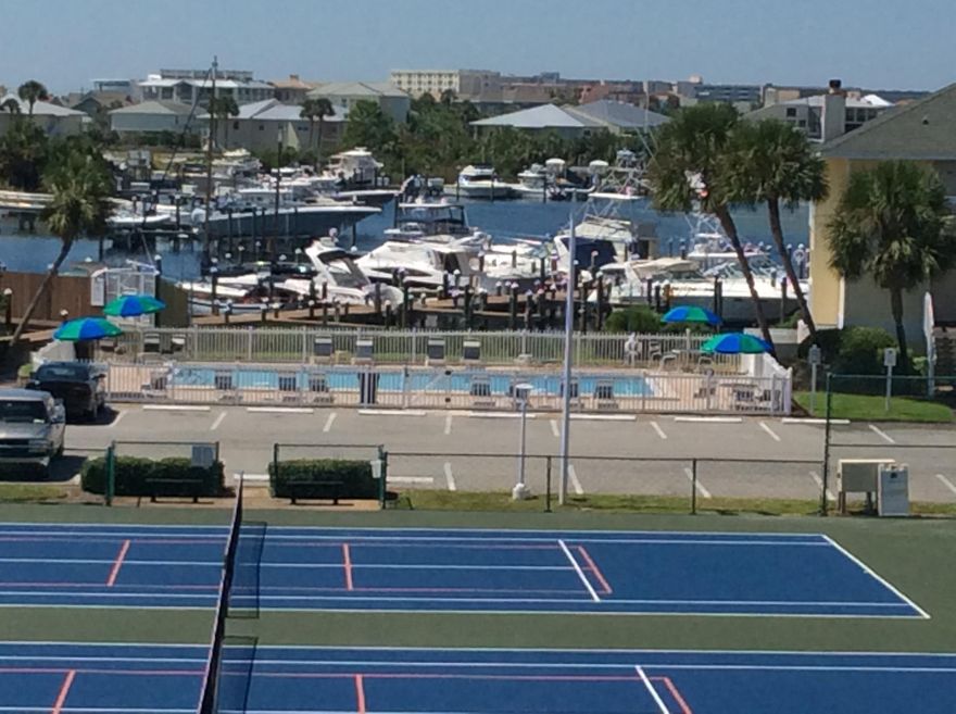 Awesome views of the Destin Harbor, Harbor front pool, tennis courts & shuffleboard from the oversized balcony of this well located condo. Beautiful new tile floors, vaulted ceilings, assigned covered parking,large laundry room, ample storage, extra windows and much more await the lucky owner of this centrally located condo in SPC's newest phase. This condo would make an excellent primary residence, 2nd home or investment rental. SPC is a residential style resort occupying 43 acres in the heart of downtown Destin. Favorite amenities include 1100 ft of beachfront,5 pools,6 tennis courts,Marina,Canal,on-site fine dining at Louisiana Lagniappe,and the favorite 9 hole par 3 pitch & putt golf course. Current tenant is moving Sept 30 & taking their furniture so condo is selling unfurnished.