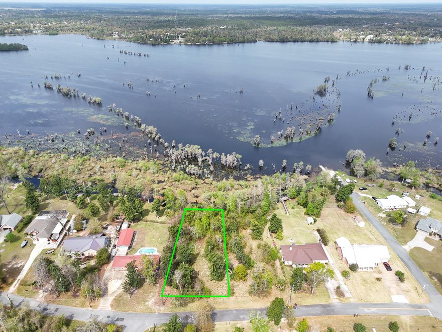 Build your dream retreat on this exceptional 0.57-acre canal-front homesite offering 100 feet of water frontage with direct access to Deer Point Lake. With serene water views & ample space to design your ideal residence, this property provides the perfect setting for a private dock, pool, workshop, or additional outdoor living features. Deer Point Lake is a 5,000-acre freshwater reservoir, formed by damming Econfina Creek, Bear Creek, and Cedar Creek, and is widely known for its outstanding fishing, boating, kayaking, and paddle boarding. Whether you envision a full-time residence or a peaceful weekend escape, this location delivers both recreation & tranquility. Conveniently situated approx 150 yards from the public boat ramp at Cedar Creek, water access is effortless. For those seeking even more space & expanded waterfront, the adjacent lot is also available, presenting a rare opportunity to own a combined 1.15 acres with 200 feet of canal frontage. This prime homesite makes an exceptional canvas for your waterfront vision with direct lake access, generous acreage, and expansion potential.