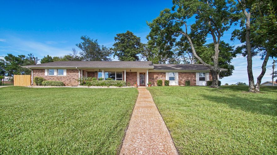 This all-brick ranch home sits atop an expansive corner lot. Featuring four bedrooms, two full bathrooms, a spacious bonus room, powder bathroom and more than 2,400 square feet of living space, this home is a rare find. Conveniently located south of Highway 98 in Panama City Beach, just minutes to the beach, Pier Park, and Frank Brown Park. Upon entering the home, you are welcomed into an airy living room filled with light through the oversized picture window. This room flows effortlessly into a large kitchen with updated cabinets and new stainless steel refrigerator. A roomy dining space makes entertaining easy. The large 16 x16 flex space is perfect for an office, studio, classroom, or playroom. Notable updates to this home include new roof (2018); new paint; laminate flooring; renovated