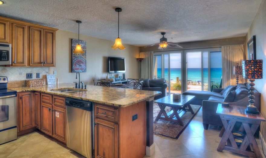 Enjoy the best that Crystal Sands has to offer! This fully-furnished rental-ready condo is a lucrative rental investment or is perfect as a great second home. Open your sliding glass doors, walk out on your patio and behold Destin's beautiful sugar sand beach that is just a few steps away. This highly desirable, walk-out ground floor condo features elegant travertine stone flooring and stylishly-textured walls and ceilings throughout. The kitchen and bathrooms boast upgraded granite counter tops, sinks, and cabinets. Besides the master bedroom, your vacation condo offers a bathroom with three rooms -- a lavatory with toilet for guests, a lavatory with toilet for the master bedroom, and a shared room with shower between them. The built-in bunk beds and sleeper sofa bring the sleeping