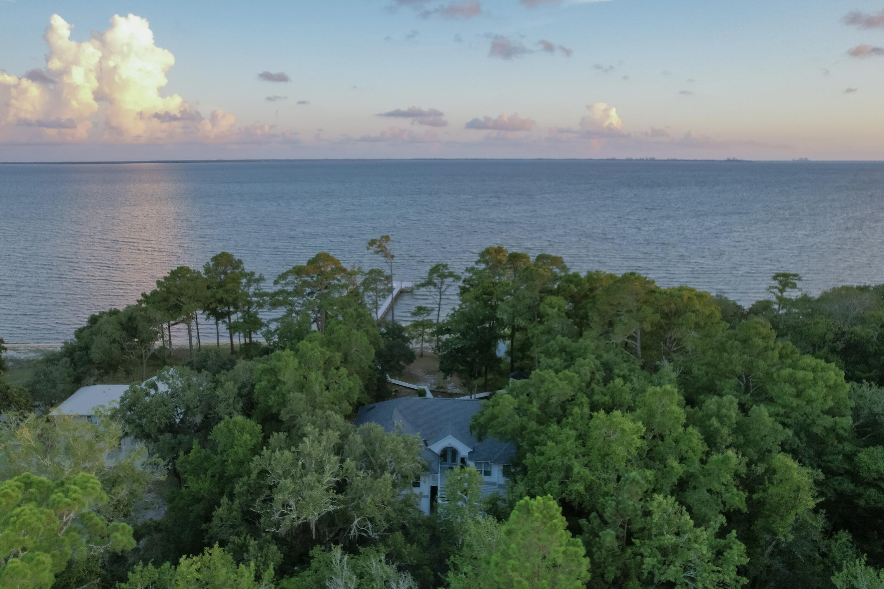 Welcome to paradise on 1.56 acres of pristine Choctawhatchee Bay. Drive through the dolphin gate and discover a stunning waterfront 4 bed, 2.5 bath home featuring an open floor plan, cathedral ceilings, and hardwood floors. The kitchen with granite island, double oven, smart refrigerator, and dishwasher leads to the living area with cathedral ceilings, skylights, and a double-sided fireplace. The luxurious primary suite features bay views, vaulted ceilings, and custom bathroom with a fluted oversized tub, tile shower, mosaic niches, LED mirror, and walk-in closet. Don't miss this private home with 108 ft of waterfront, dock, and beach for dolphin sunsets! *OPEN HOUSE AUG. 2&3, 11 AM-2 PM. Seller offering up to $10,000 in closing cost assistance with acceptable offer at closing. The spacious downstairs boasts an oversized two-car garage, an additional air-conditioned room with closet, and room for a gym or workshop. Step outside to the real showstopper: an impressive 108 feet of private bay waterfront with a sandy beach and a dock connecting to a freshwater branch flowing into the bay nestled alongside the property. There are two pavilions with a swing, benches, and a covered outdoor area with a cargo elevator, turf, and padded area perfect for grilling and entertaining. Whether you're enjoying water excursions or relaxing at your oasis to watch beautiful sunsets and waves on your private beach, every day feels like a vacation.
The scenic Choctawhatchee Bay is renowned for its excellent fishing opportunities and provides direct access to the world-famous Crab Island. Just a short drive (approximately 15 miles) away lies Destin and 30-A, known for their world-class beaches, shopping, and dining options. Minutes from your beach, you can enjoy fresh catches at Nick's Seafood Restaurant, when you're not reeling in your own from your private dock with jet-ski lifts. While you'll never want to leave, it also offers incredible potential as a revenue-generating vacation rental property while avoiding the typical neighborhood and HOA hassles. Nestled in a secluded bay-front haven surrounded by nature, this dream home offers a unique blend of peaceful private waterfront living and convenient access to Florida's Gulf Coast.