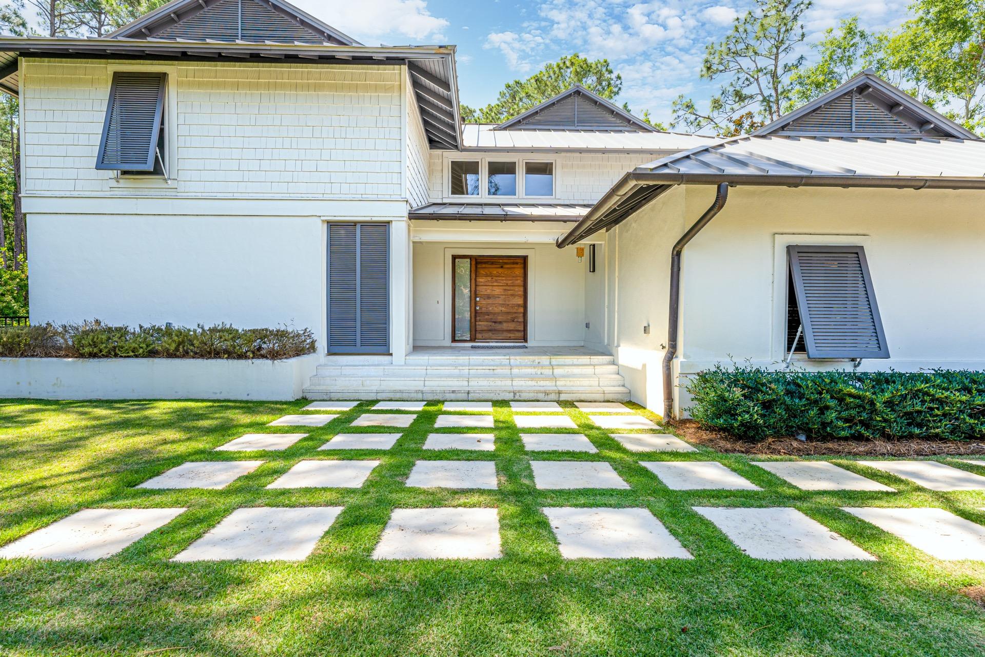 Tucked in the Pines in the Exclusive Enclave of Burnt Pine is where you find this PRIVATE 3BR/3.5BA home with Bunk Room Refreshingly Unique in Design for the area, The Simplicity of the exterior reveals a touch of Modern Esthetic. As you approach the entry and the fabulous oversized, Custom Hickory Front Door with it's sleek polished nickel hardware, it is apparent you have arrived somewhere stylish.As you enter No garish colored walls, heavy moldings or overly ornateness here...only a soothing, sophisticated backdrop of seamless neutral color, luxurious white Peacock Paver floors and clean, uncluttered lines.. The Main Living Area beckons you up the stunning white stone oversized staircase. Home has a Private Master Suite, Spectacular Pool,  Outdoor Living Area and Full House Generator
