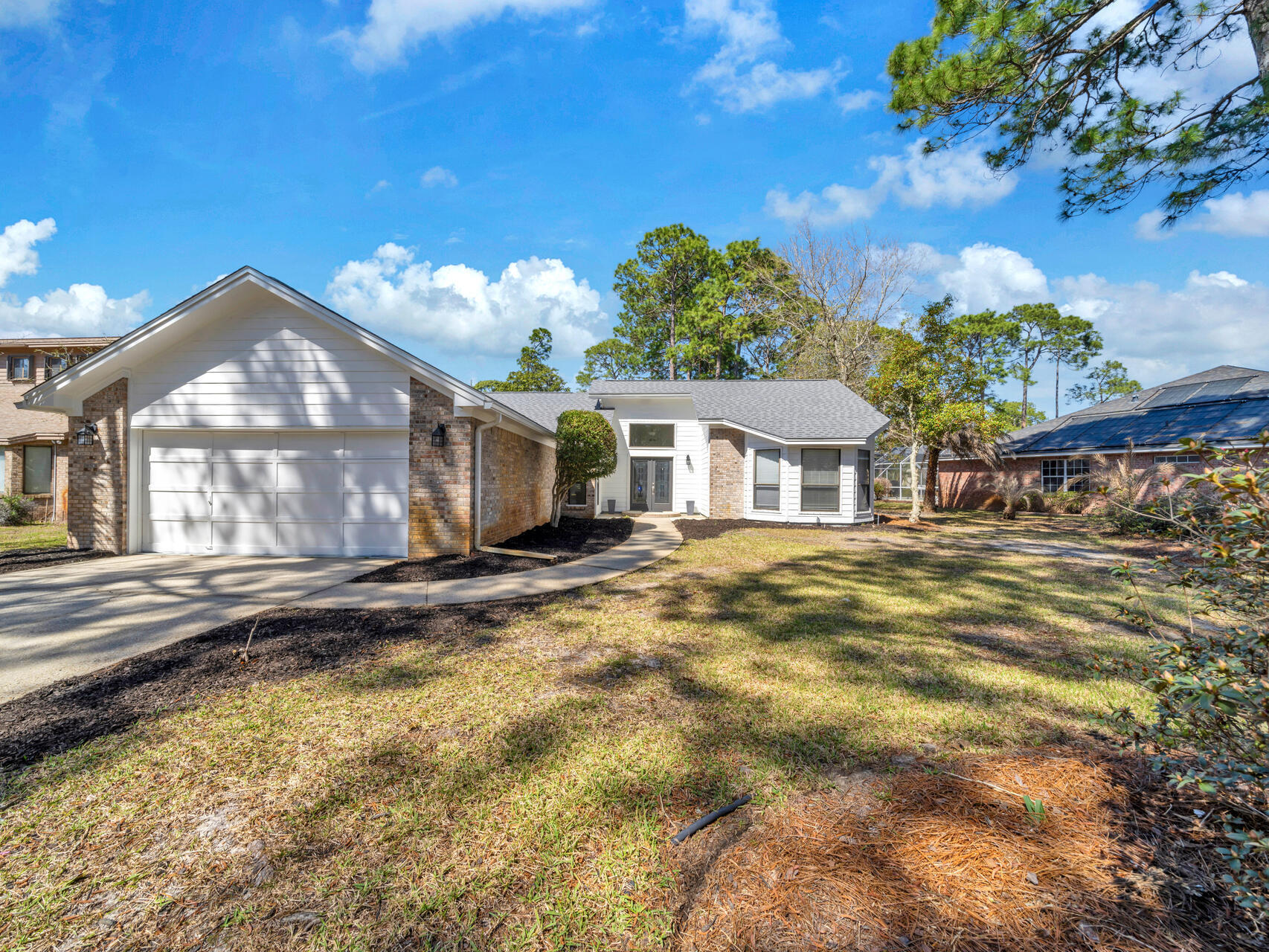 Elegant 3 bedroom, 2 bath home with 2115 sqft and unobstructed views of the 3rd green and the Fairway of the Bluewater Bay Golf Course in the Saint Andrews Village Subdivision! This home is located in a waterfront community that offers a Golf Course, Marina, Tennis Center, Swimming pools, clubhouse, biking paths and trails. NO HOA!! Niceville is home to the some of the best schools in the state of Florida! This home sits on a .46-acre lot with gorgeous mature vegetation and features a long driveway for extra vehicle/RV parking, a large paver patio, gutters, brick veneer, Hardi Board Siding, and a two-car garage. This home is perfect for entertaining guests with the large screened enclosure and paver patio! Watch golfers on the green or take your own golf cart to the golf club! The kitchen features a gas 5-burner, Kenmore Elite 40 inch dual oven and stove, a stainless vent hood, side by side stainless refrigerator with ice maker, dishwasher and microwave. The kitchen has custom shaker cabinetry with crown, an island and a stone backsplash. A large eat in kitchen area overlooks the screened patio and golf course. The eat in kitchen area features a bay window. The kitchen opens to the living room and dining room! The separate dining room features a new chandelier and views of both the golf course and front yard! The living room has vaulted ceilings, a fireplace, recessed lighting, floor electrical outlets for lighting, and a custom ceiling fan. Adjacent to the living room and overlooking the back yard and golf course, is a study with built in book cases. This space could be a home office or 2nd living room area! The primary bedroom is separate from the guest bedrooms and offers maximum privacy. In addition, the primary bedroom has French Doors leading to the open paver patio. There are golf course views form the bedroom! The ceilings are vaulted and the space is large enough for a king size bed and furniture! The ensuite bathroom features a large garden tub, walk in shower, and custom furniture piece vanity! Items that have been updated are the mirrors, lighting, faucets and fixtures! The primary bedroom also features a large walk in closet with custom shelving. The guest bedrooms are spacious and large walk in closets and shelving. The front guest bedroom features a bay window and picturesque views of the front yard. There is a hall bathroom with updates that includes, new mirror, lighting and fixtures. The separate laundry room is adjacent to the kitchen. The two car garage floor was recently painted! The garage features a sink basin and a separate side door to the paver walk way. The home has a new roof (2023) with underlayment, tankless Ranai hot water heater (2106), HVAC and gas furnace (2017). The new roof and underlayment adds to the discount on the annual insurance cost! The interior and exterior of the home was painted in 2023. The sprinkler motor was repalced and a Rain Head timer was added (2023). This home is located close to restaurants, shopping, excellent schools, and churches. There are pickleball courts and tennis courts near by and just a short drive to the white sandy beaches of the Gulf. Buyer to verify all dimensions and information.